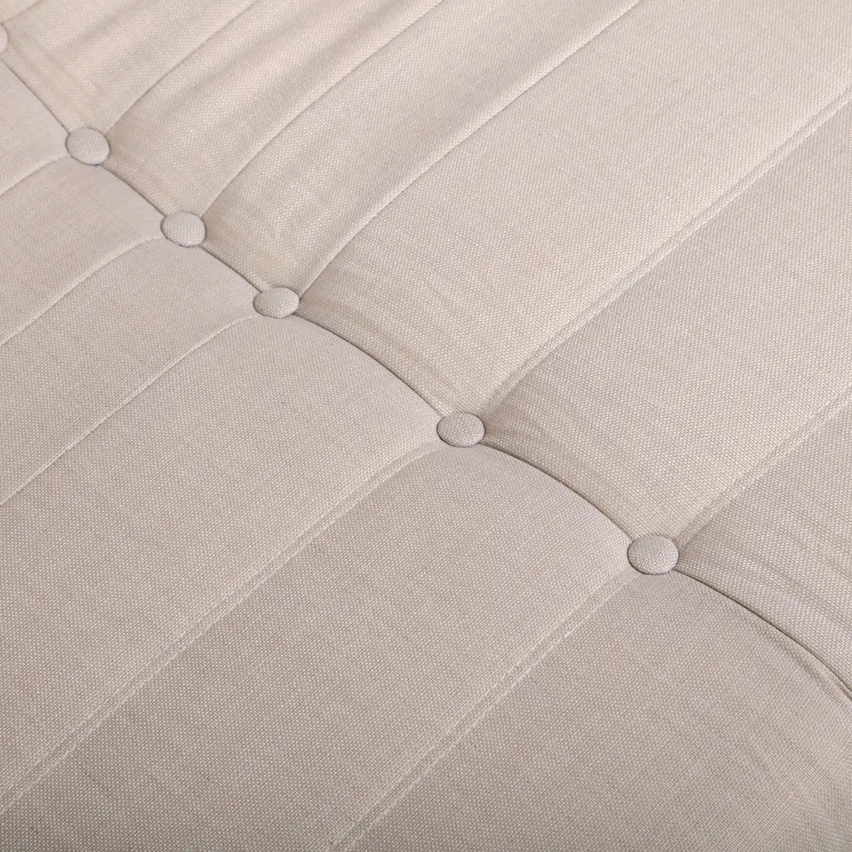 Beige fabric loveseat chair back with tufted button accents and stitched channels