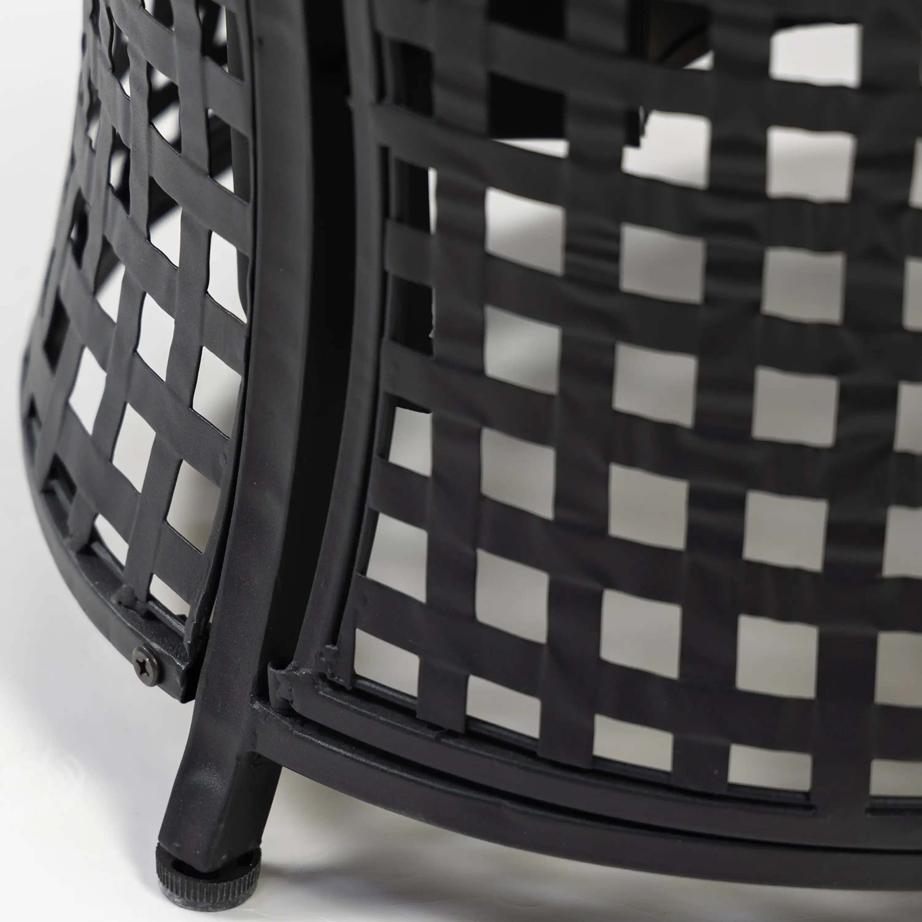 Black woven metal lattice side of an outdoor propane fire pit table