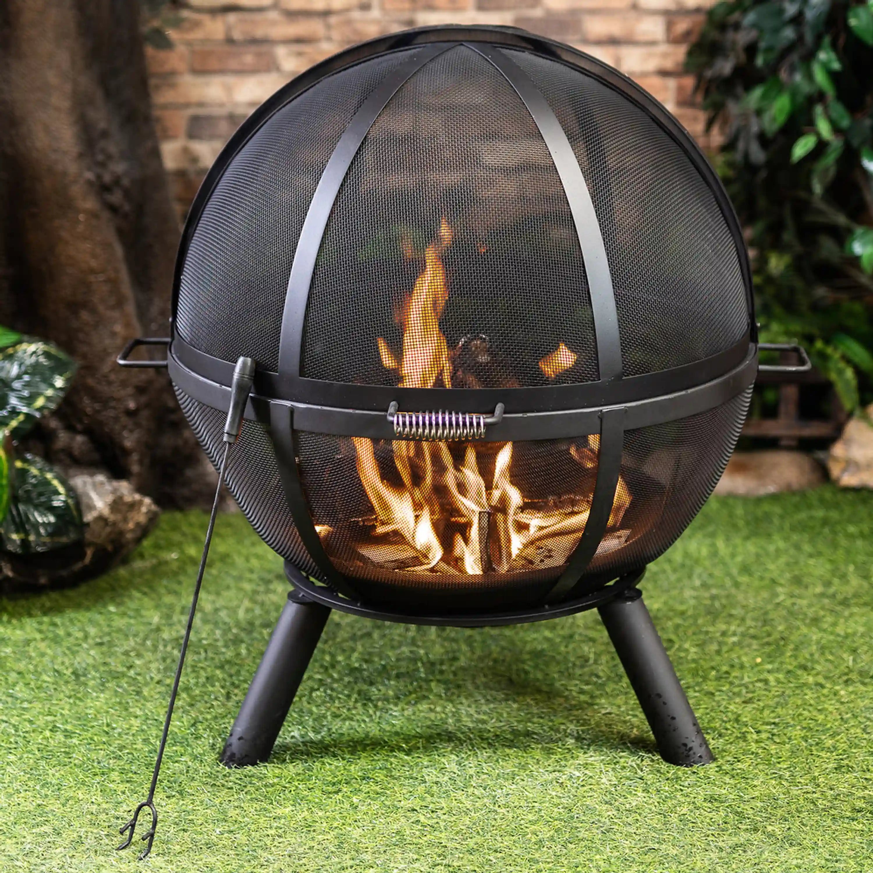 Sphere outdoor fire pit with black mesh dome and burning flames, front ring handle bar