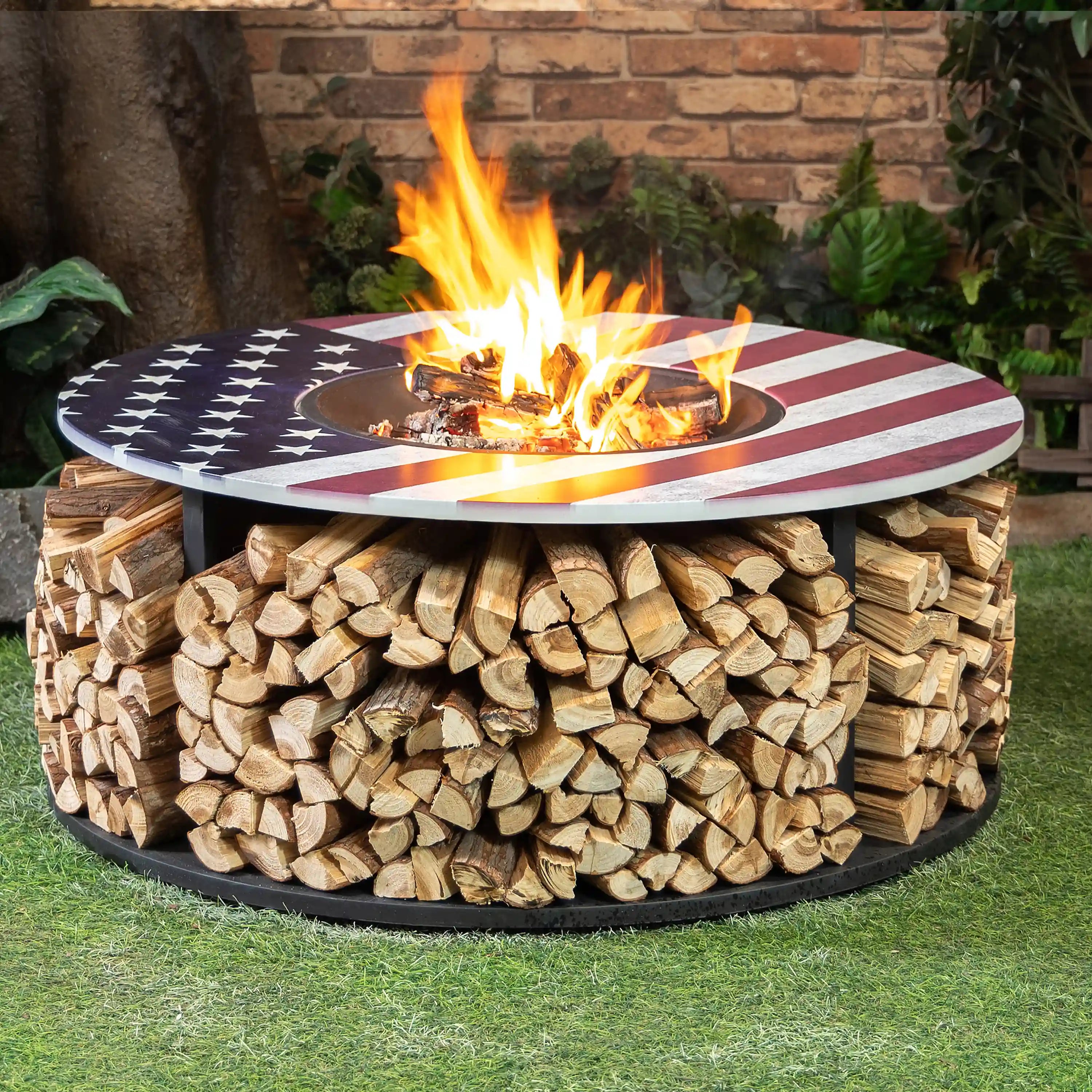 Fire pit burning with flames and stacked logs under a star-and-stripe lid