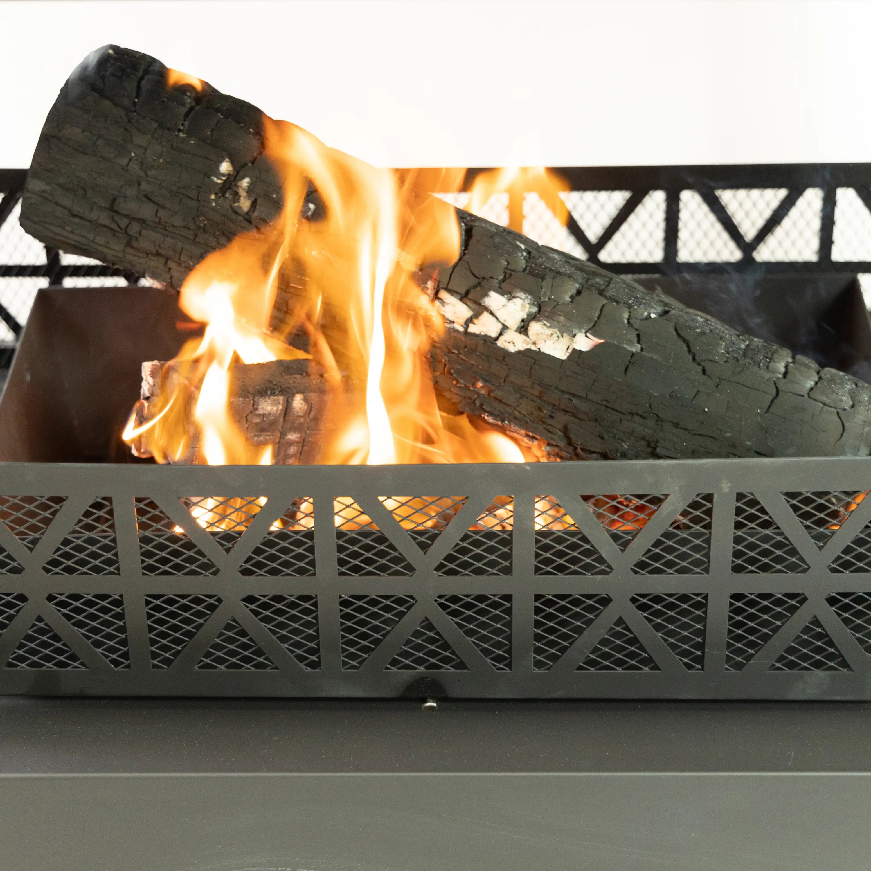 Outdoor steel wood-burning fireplace with visible flames and log grate front