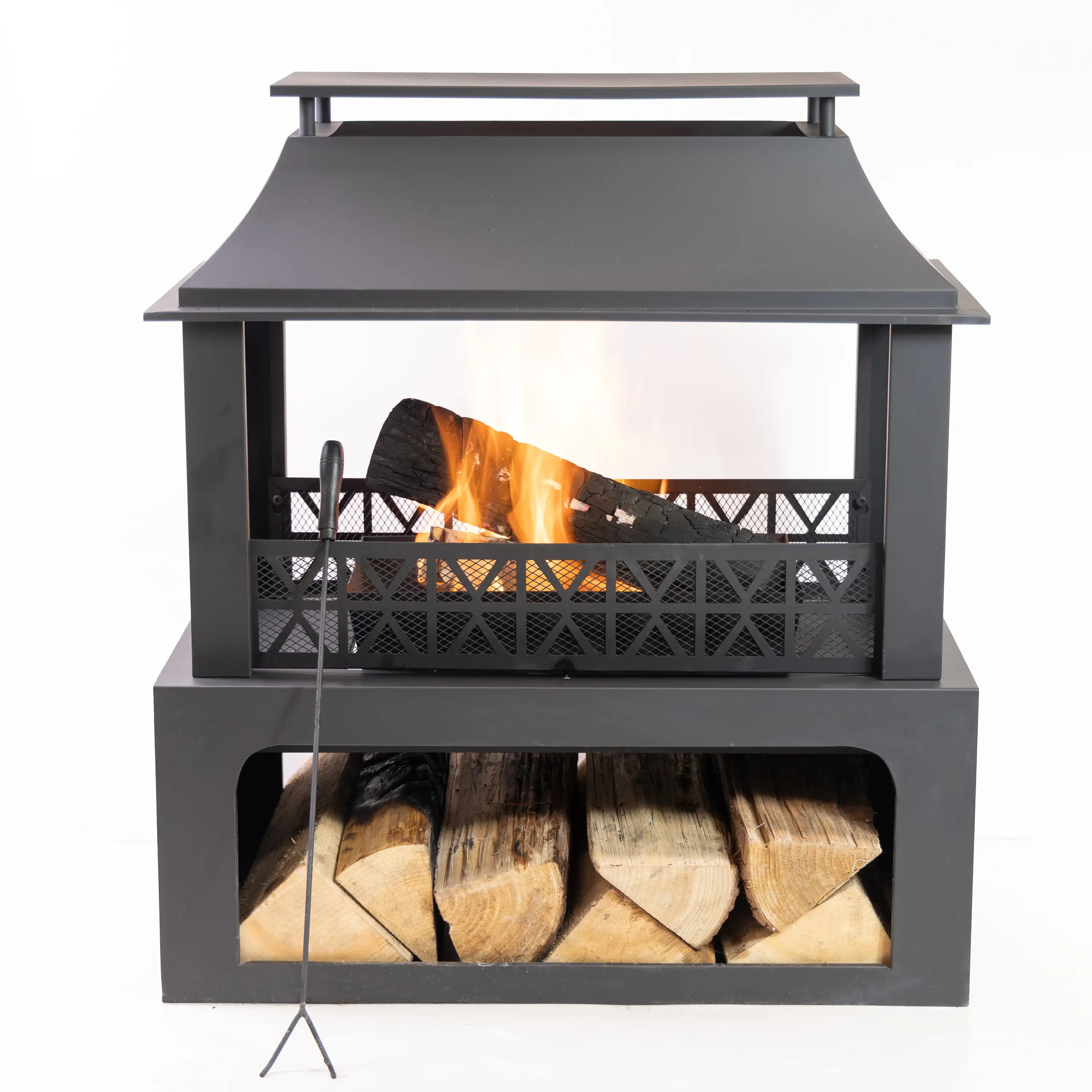 Outdoor steel wood-burning fireplace with flames and front log storage compartment