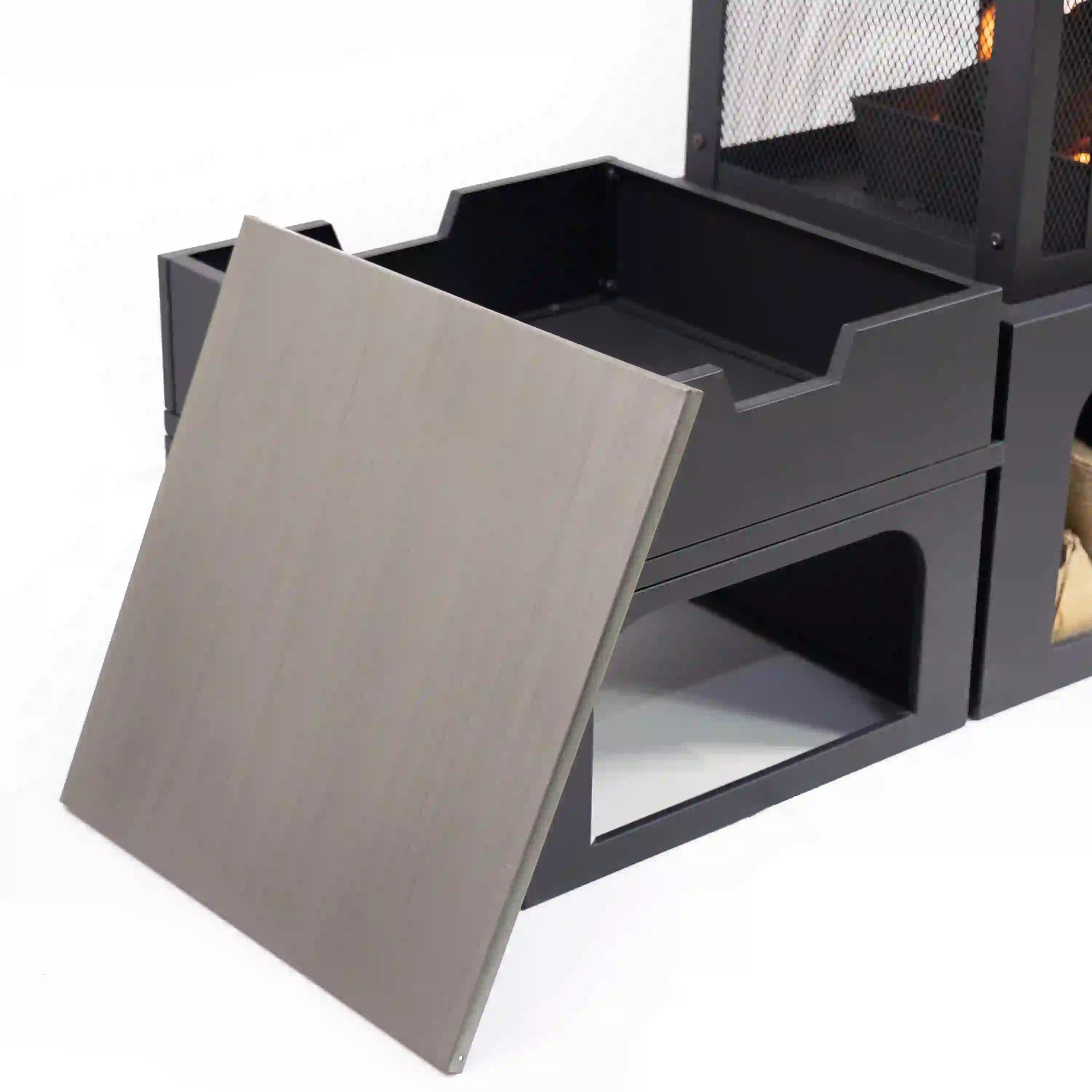 Open side storage drawer with interior compartment on outdoor wood-burning fireplace