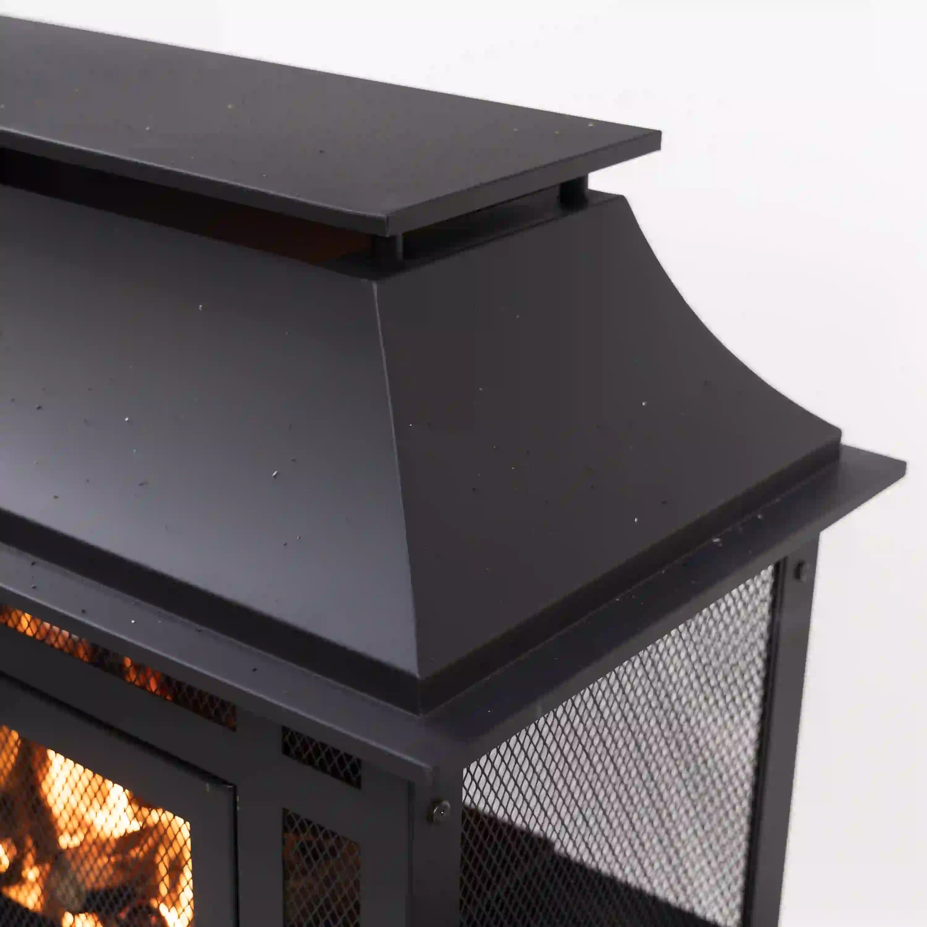 Fireplace hood and side rail detail above mesh front on outdoor steel unit