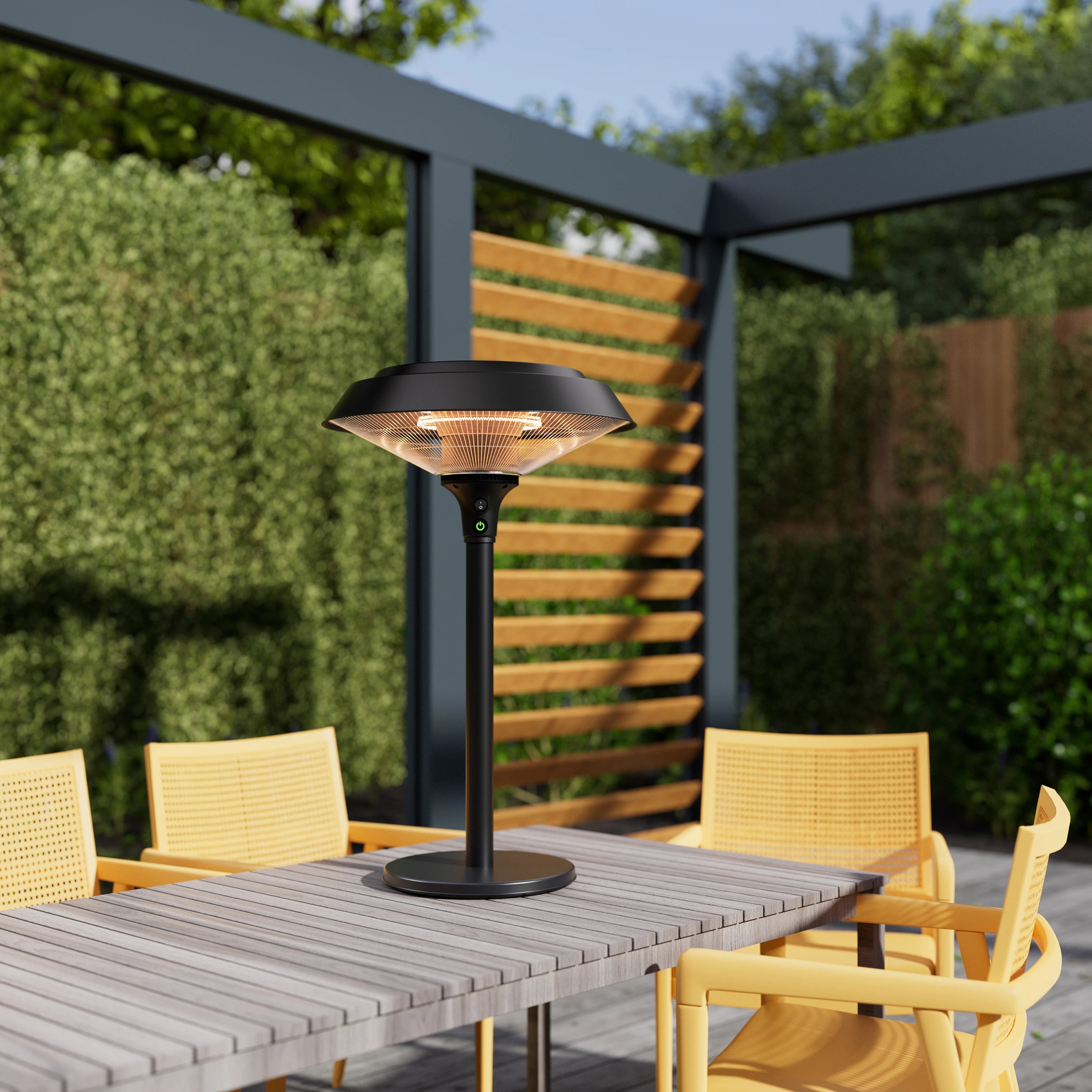 Black standing electric heater with glowing carbon fiber tube and round pedestal base.