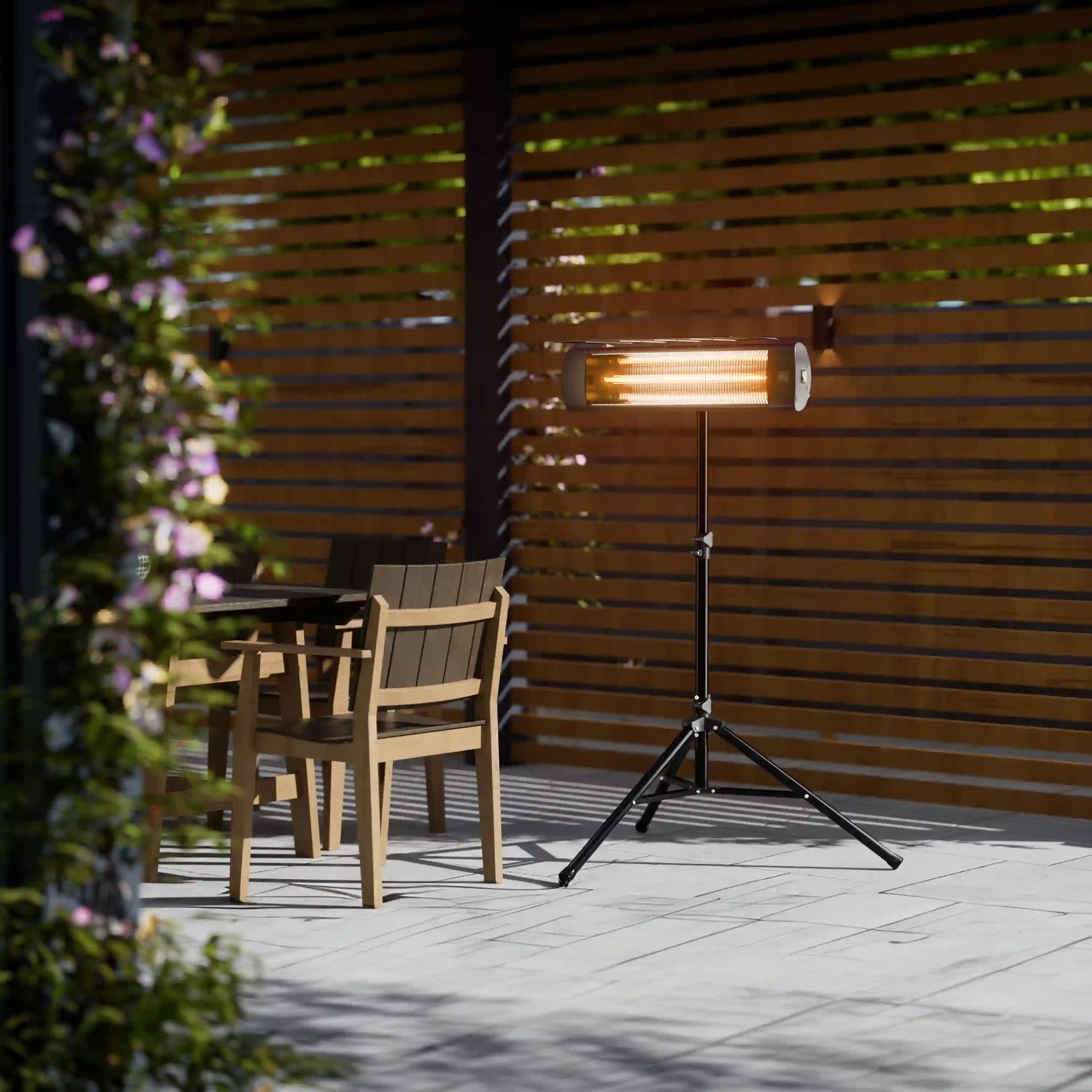 Outdoor infrared carbon-fiber stand heater on tripod with glowing tube near patio chairs