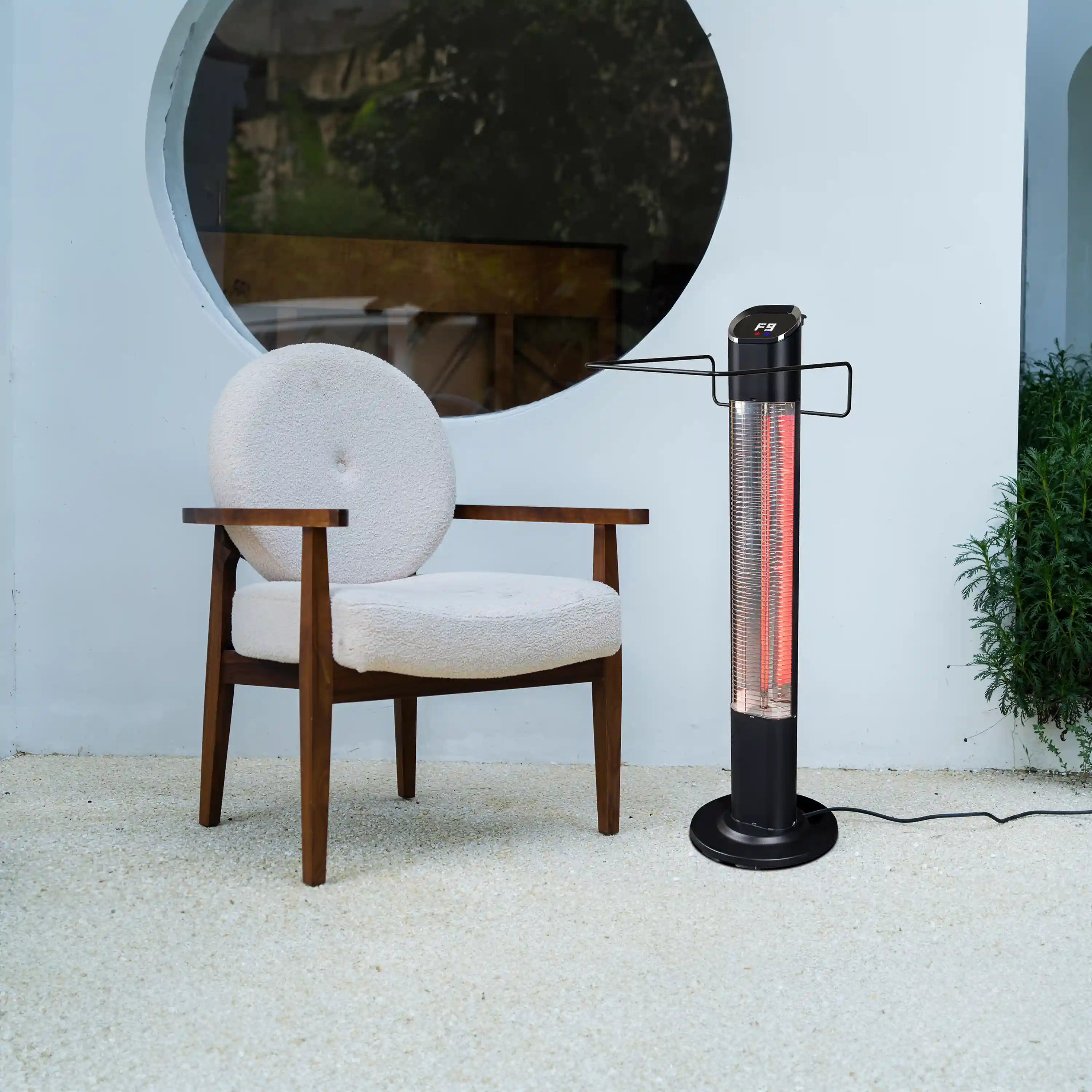 Electric tower heater outdoors with glowing carbon fiber tube inside the front grille
