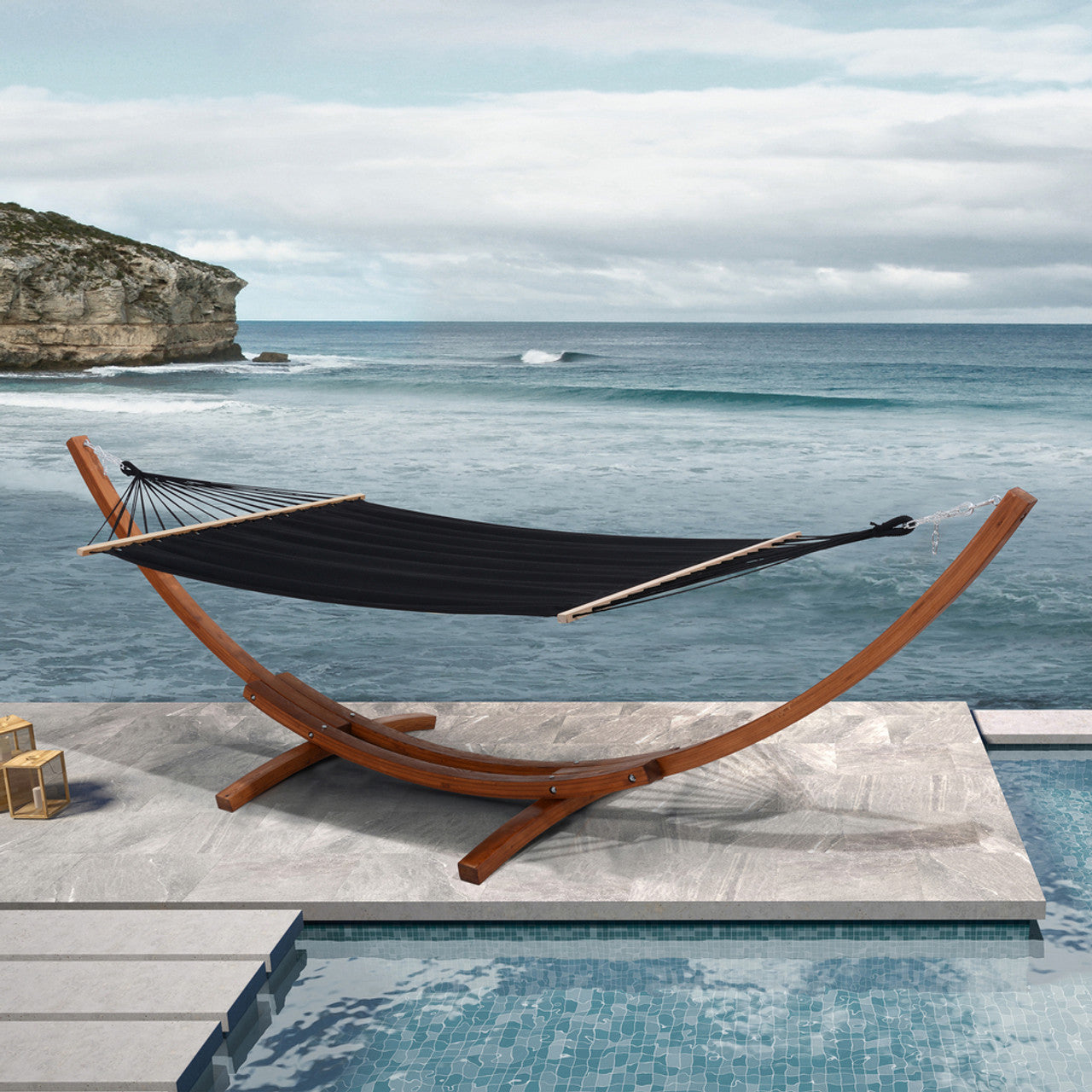 Cedar wood hammock on patio deck with black fabric bed and poolside setting