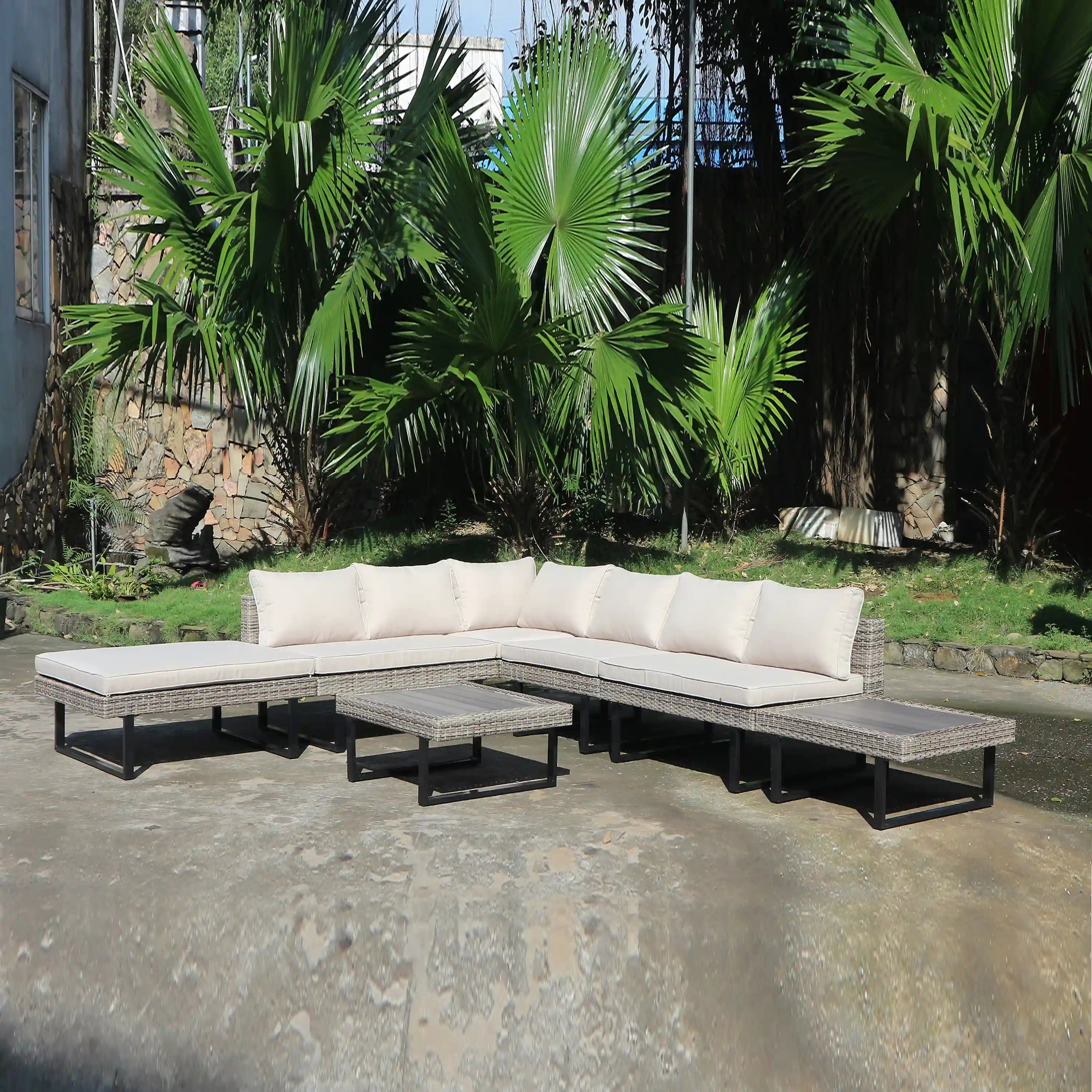Outdoor patio sectional with off-white cushions on woven wicker frames and dark legs