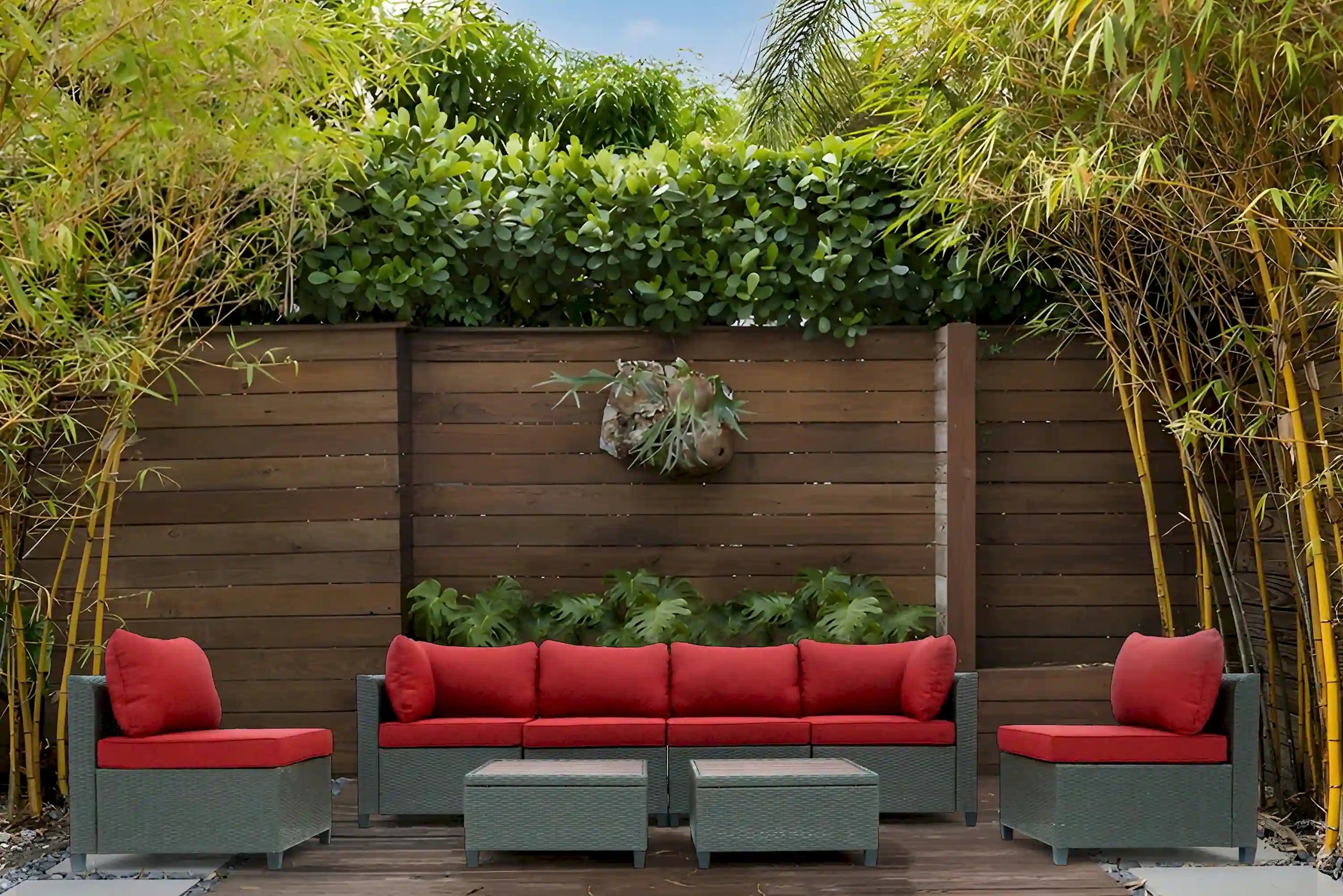 Outdoor wicker sectional sofa set with red seat cushions and matching side units