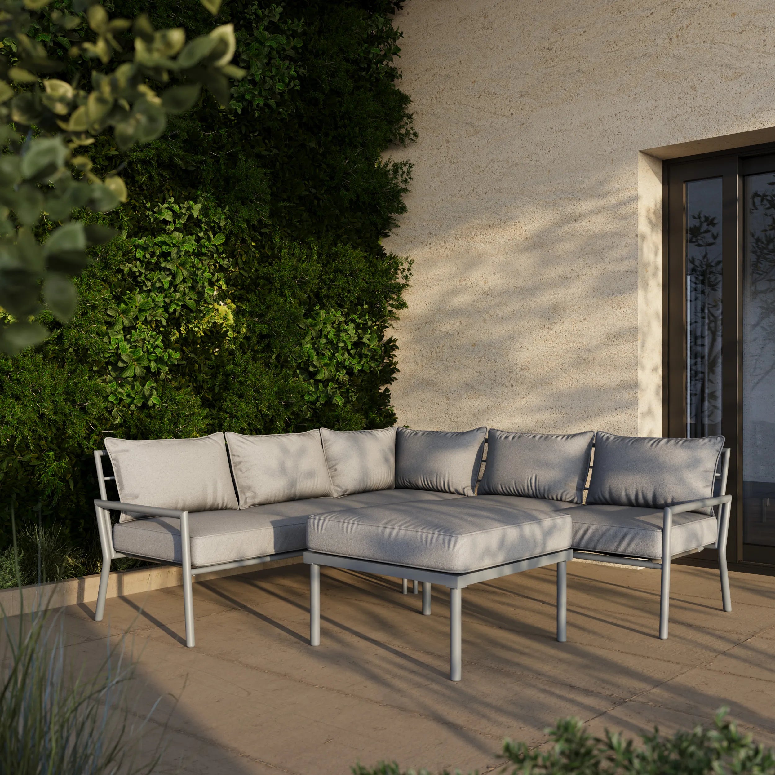 Gray outdoor sectional sofa with ottoman, box cushions and metal armrests