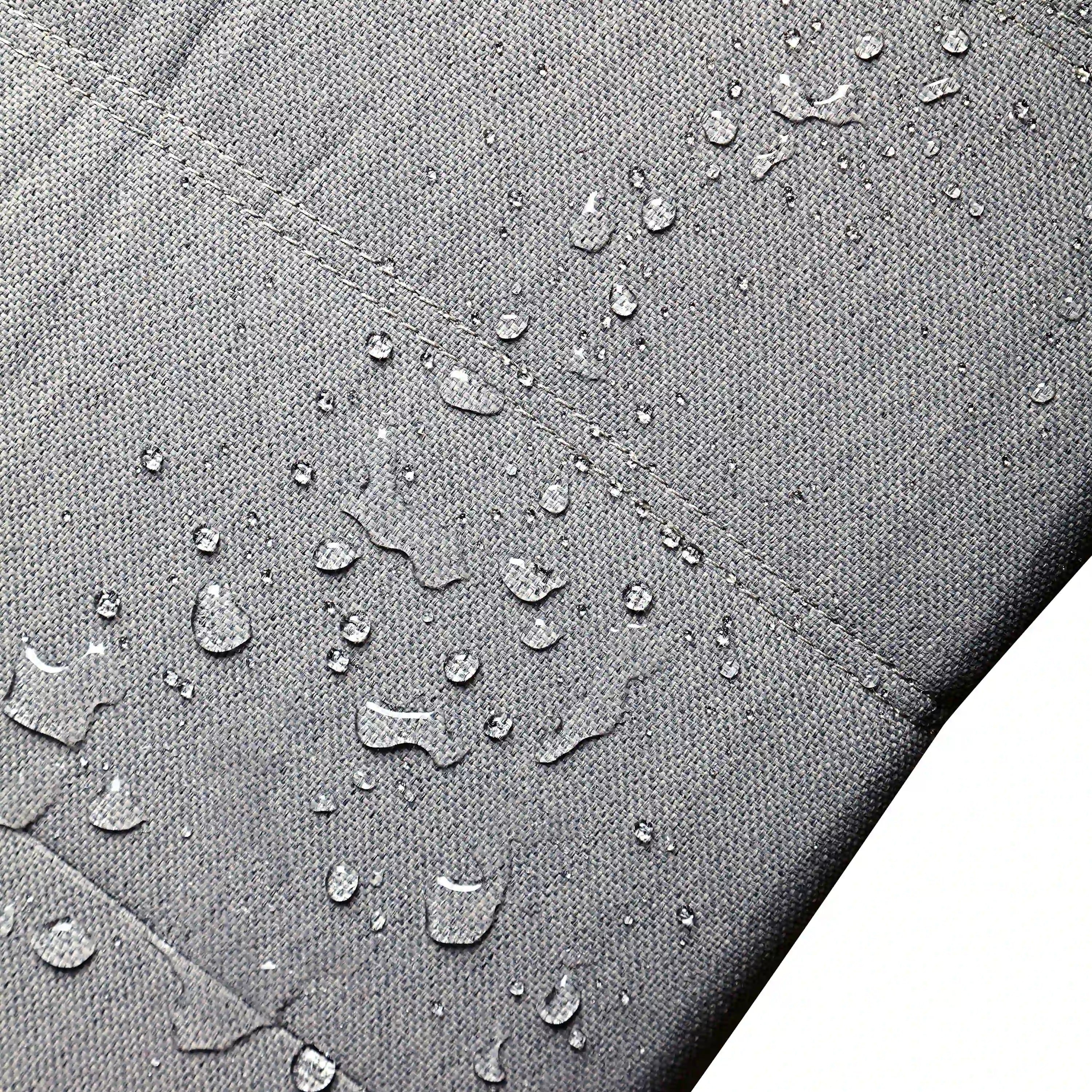 Close-up of gray water-resistant outdoor fabric with droplets on the weave