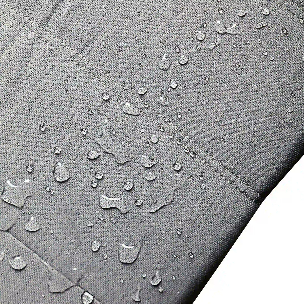 Water-resistant gray outdoor fabric upholstery with visible moisture droplets