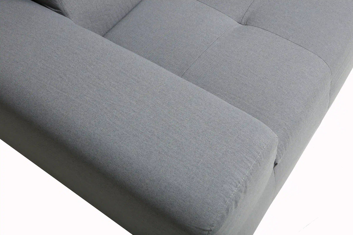 Gray outdoor sofa seat cushion with textured fabric and stitched piping along the seam
