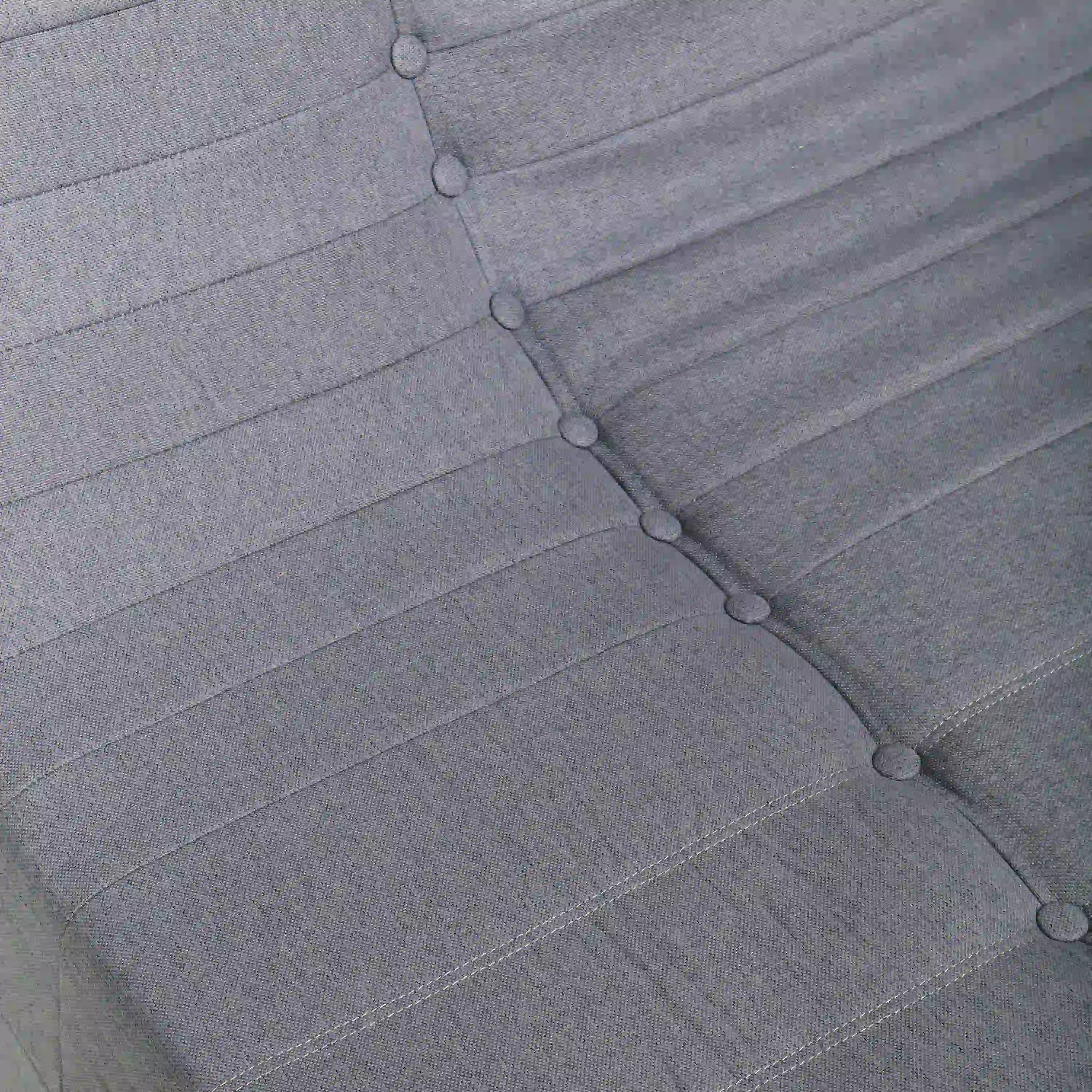 Gray outdoor cushion fabric with stitched lines and tufted button details