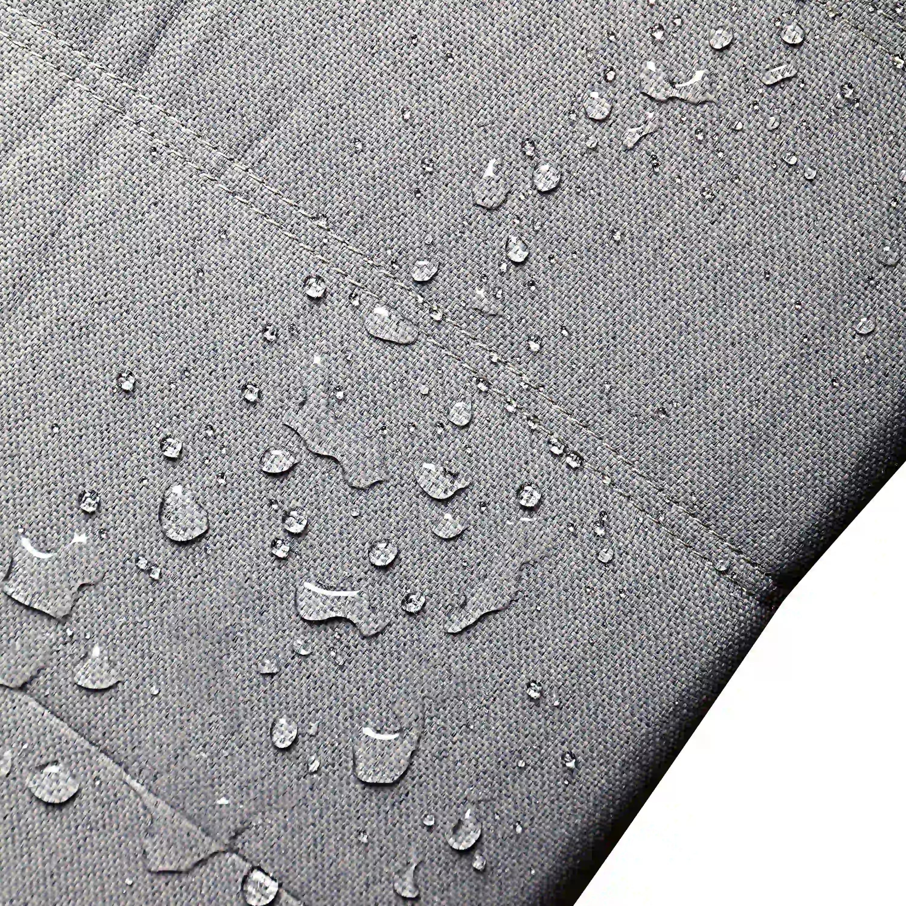 Gray outdoor fabric with water droplets over stitched upholstery