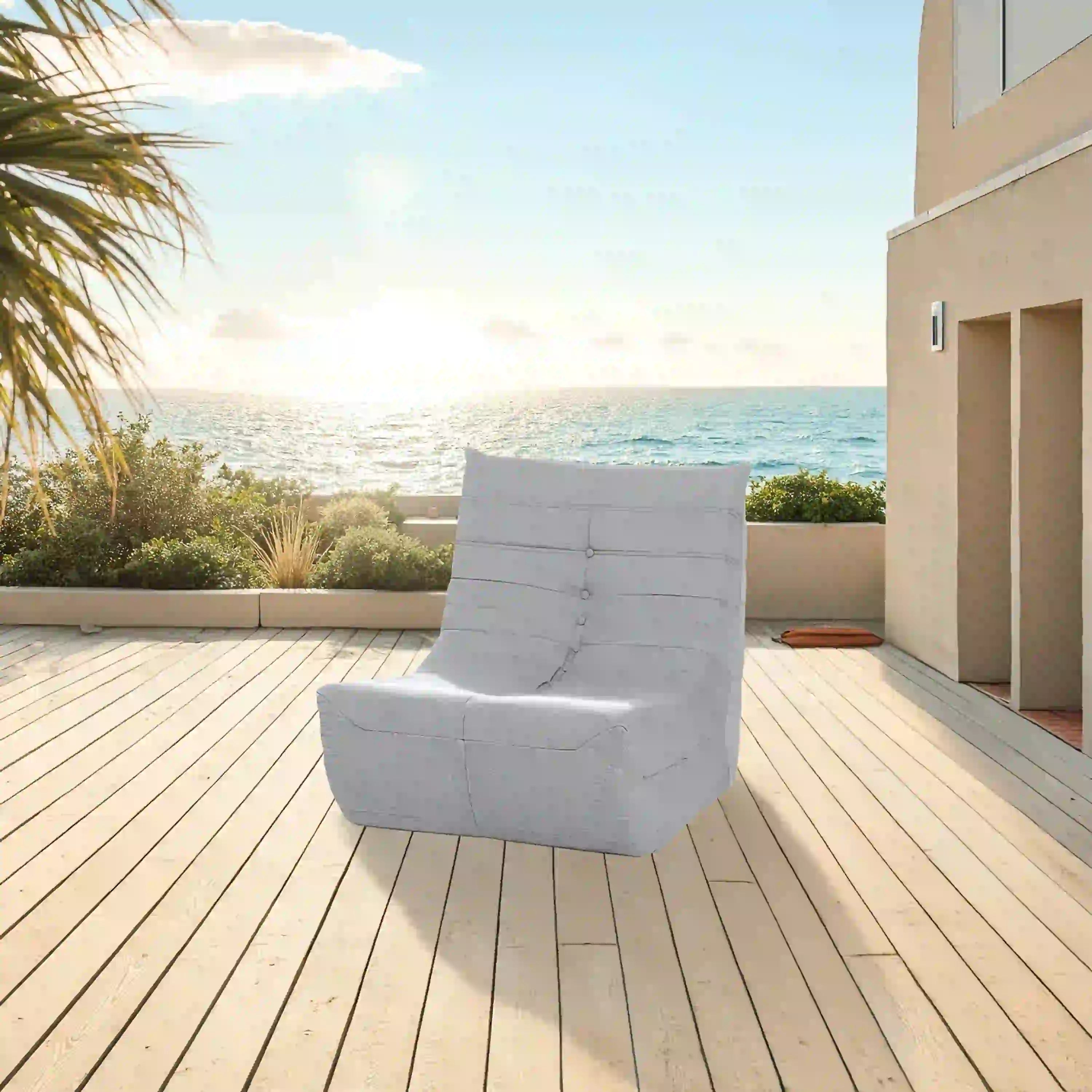 Gray outdoor compressed foam lounge chair with button-tufted back and wide armrests
