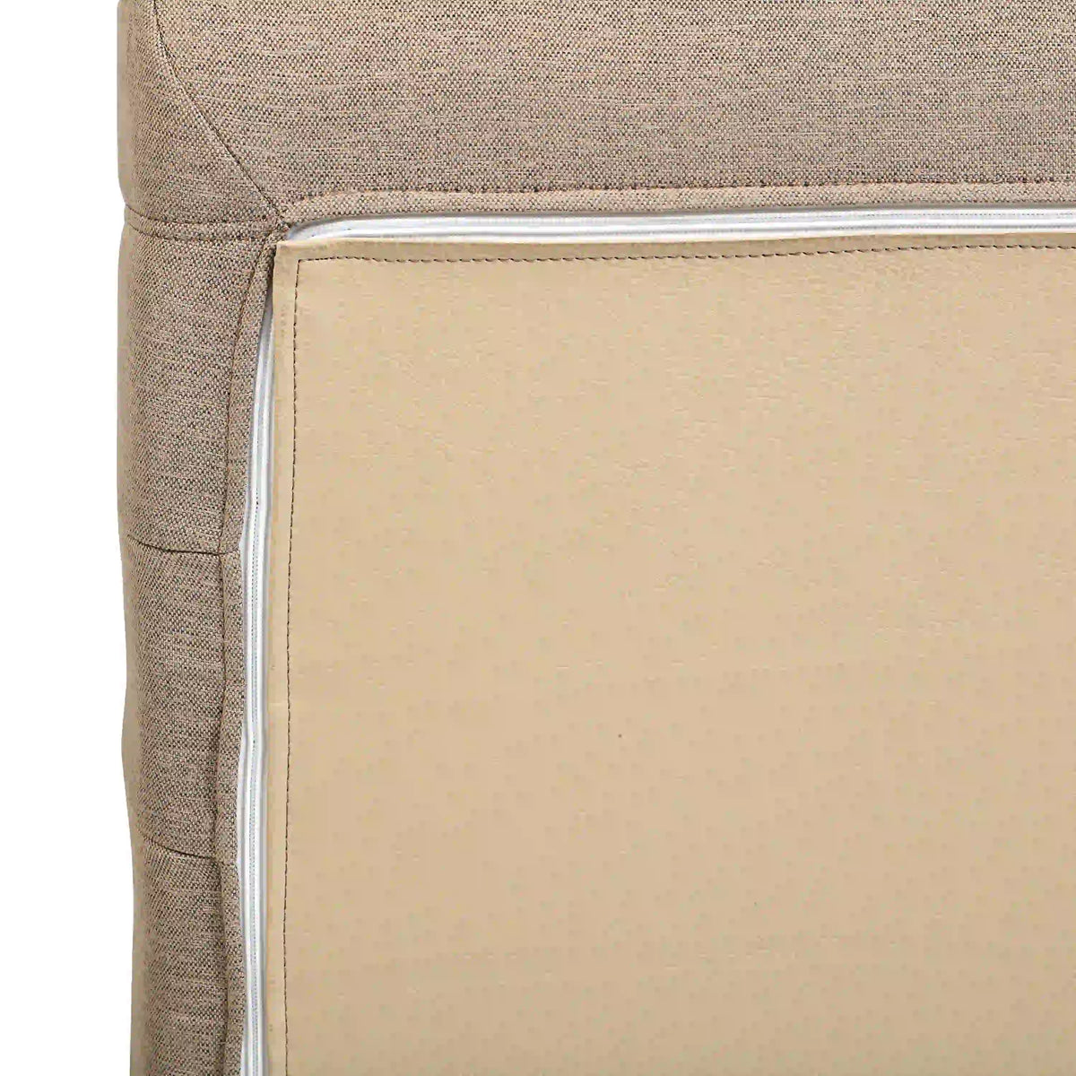 Beige chair arm corner with inner panel edge and stitched upholstery border.