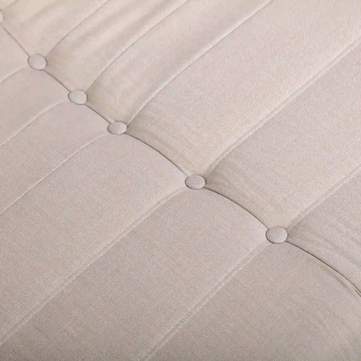 Beige tufted outdoor foam sofa with buttoned channel stitching on the seat