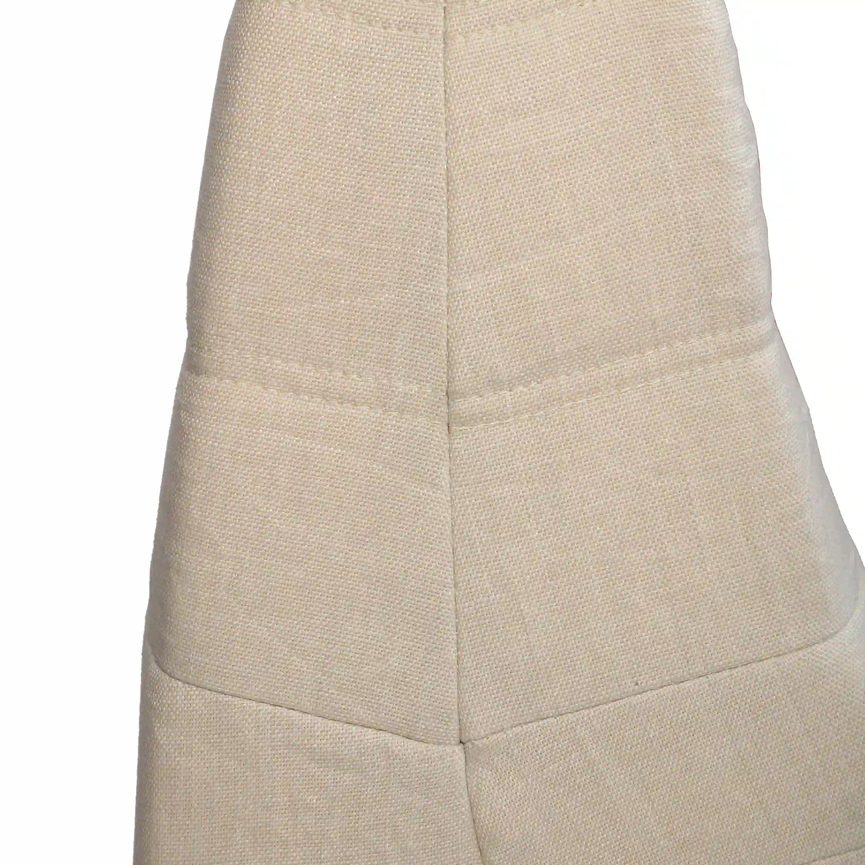 Beige outdoor compressed foam chair, side view with padded panels and vertical seam lines