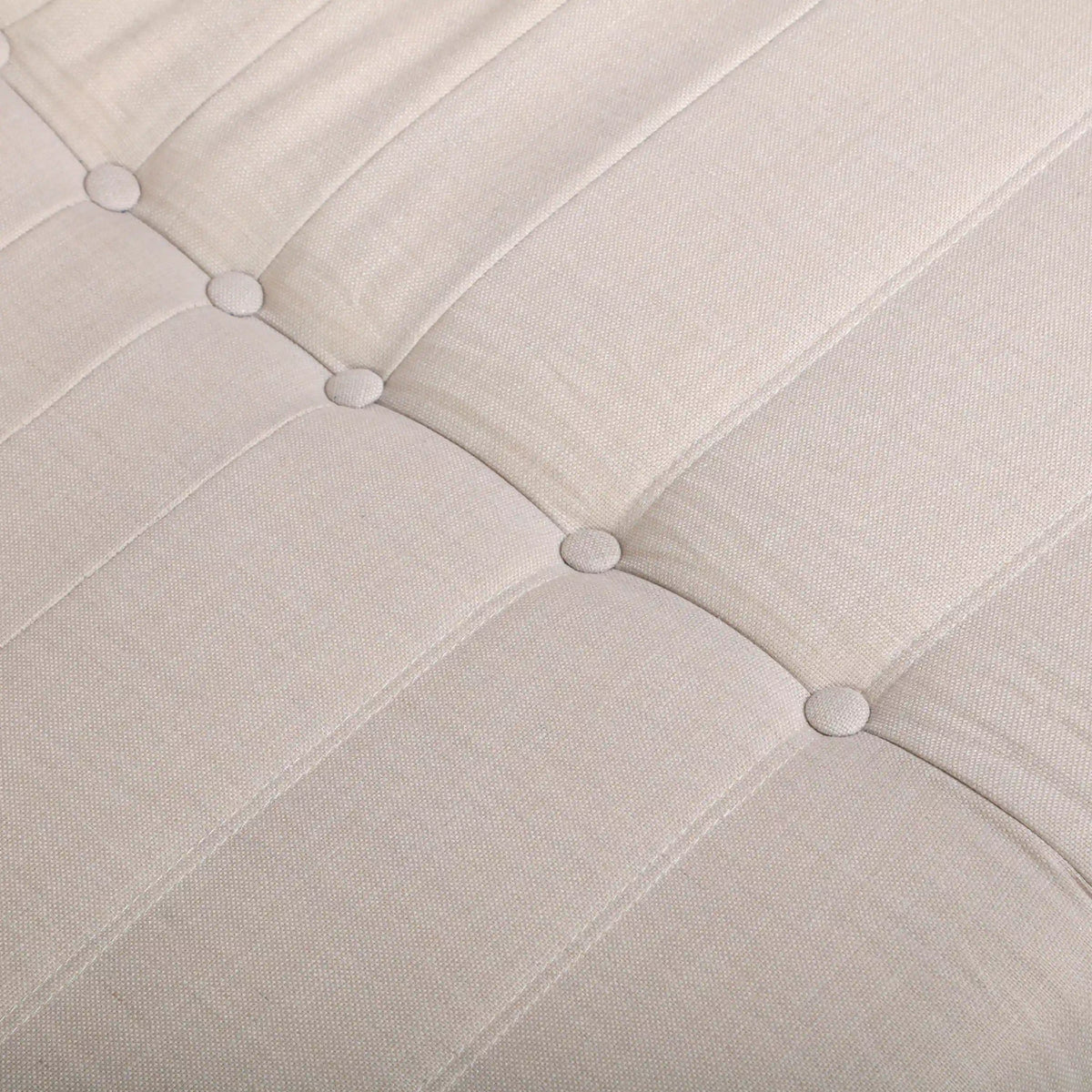 Beige sofa back cushion with tufted buttons and channel stitching detail