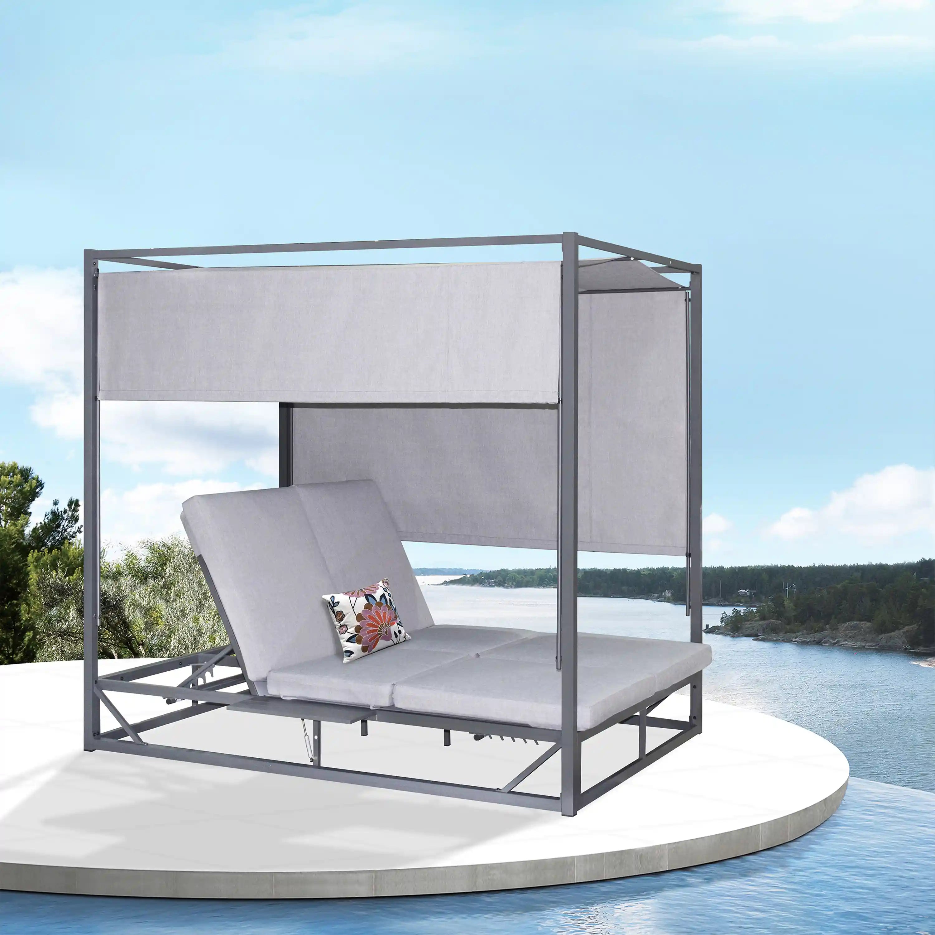 Gray outdoor patio daybed with canopy panels and bench cushions, front-left view