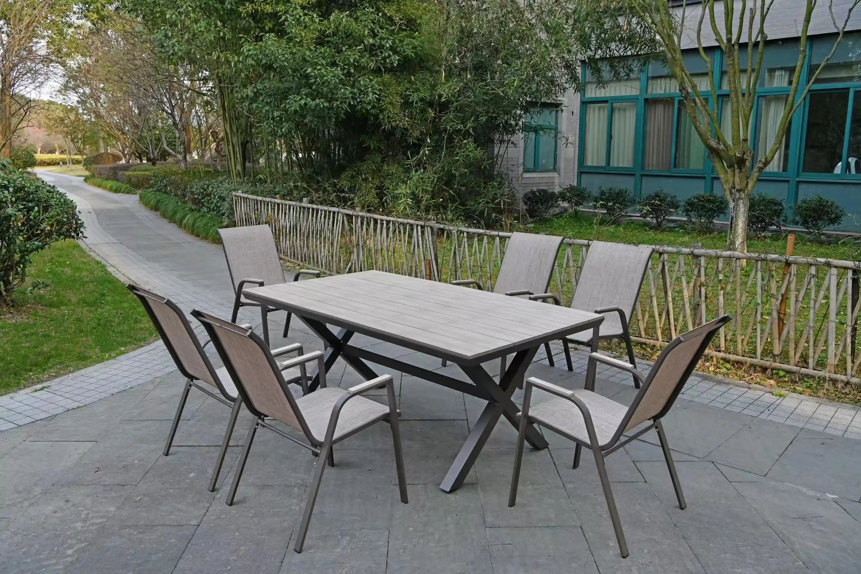 Patio dining set with square table, six gray chairs, and dark metal frames