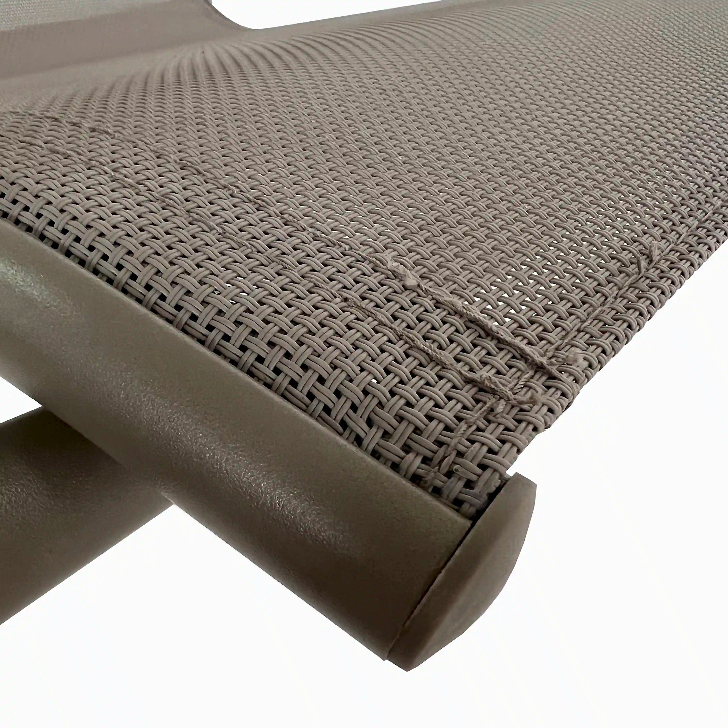 Close-up of dark woven mesh patio chair seat with metal frame and arm detail