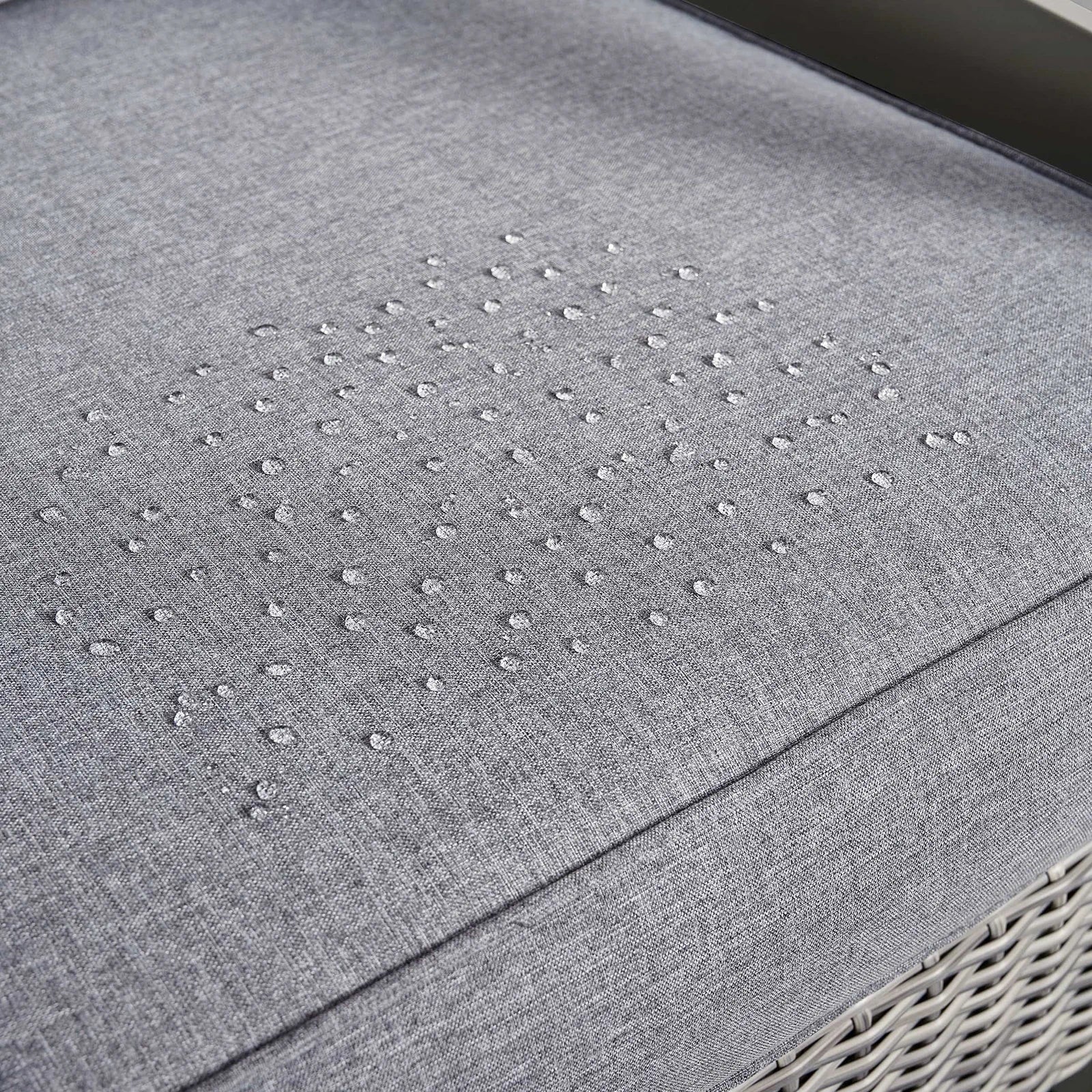 Gray outdoor patio cushion with subtle light dot pattern on textured fabric