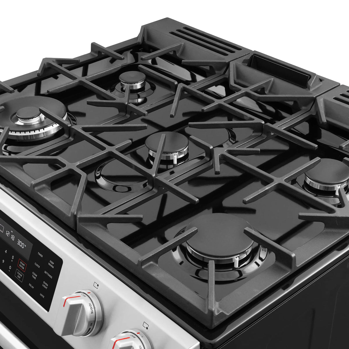 Stainless steel gas cooktop with five black burner grates and control knobs