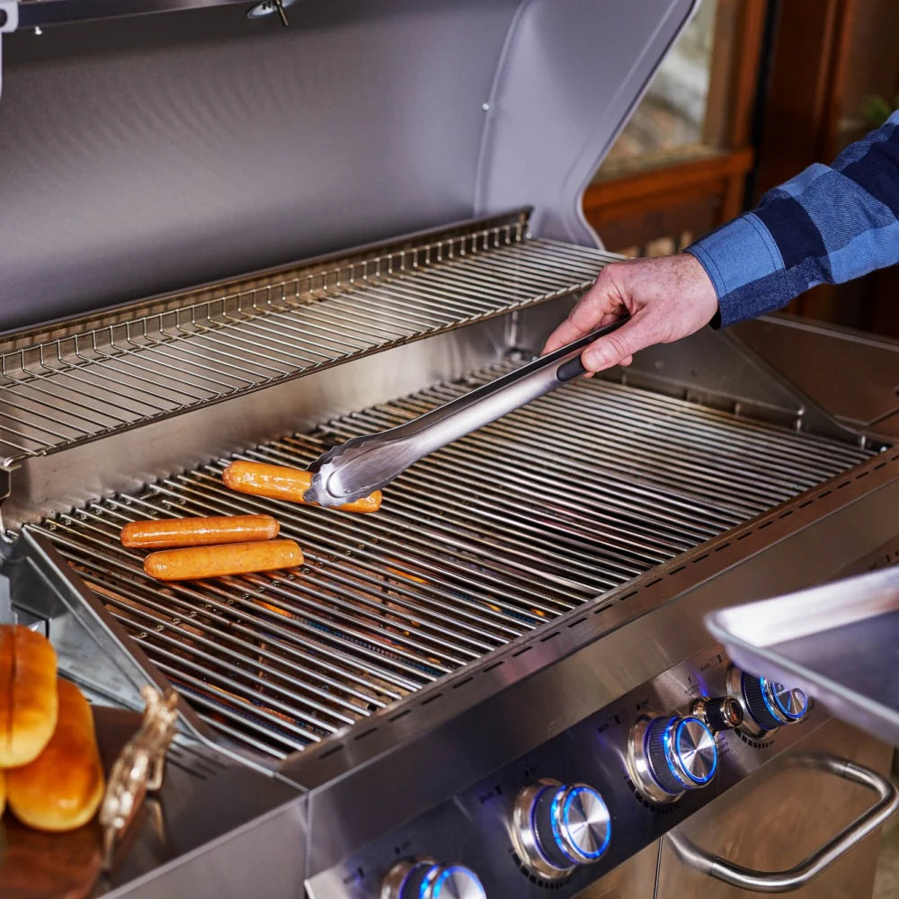 Open stainless grill hood with warming rack and grates, sausages on the burners