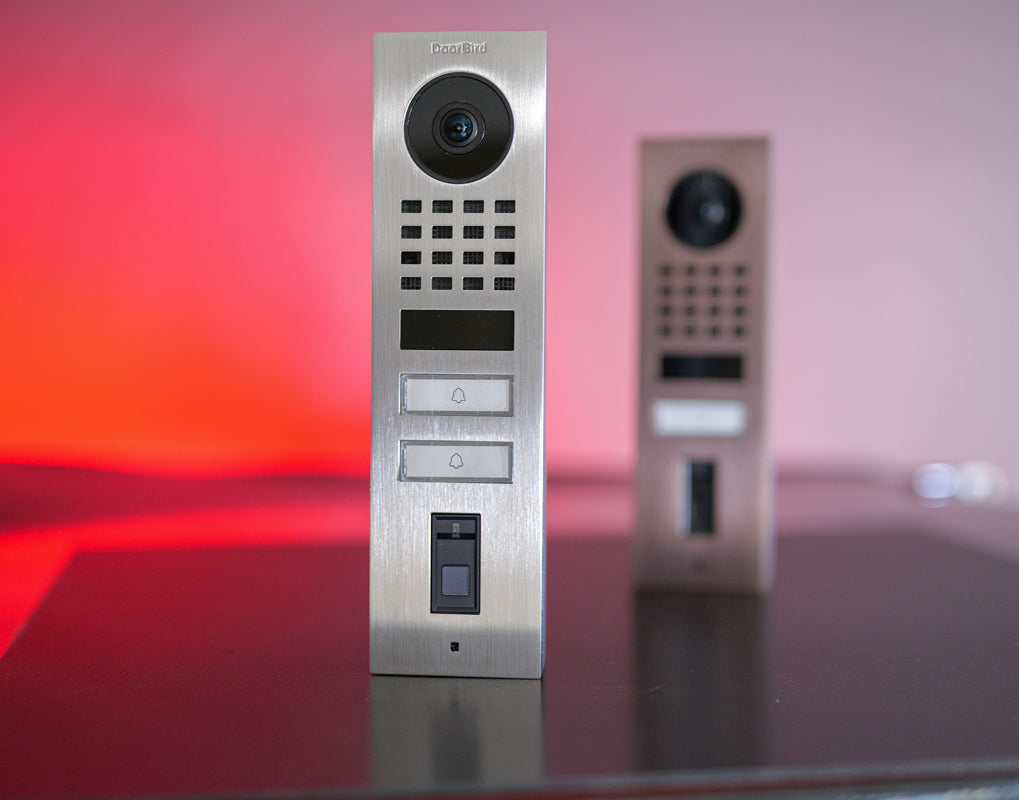 Front view of stainless video door station with camera, keypad grid, and call button