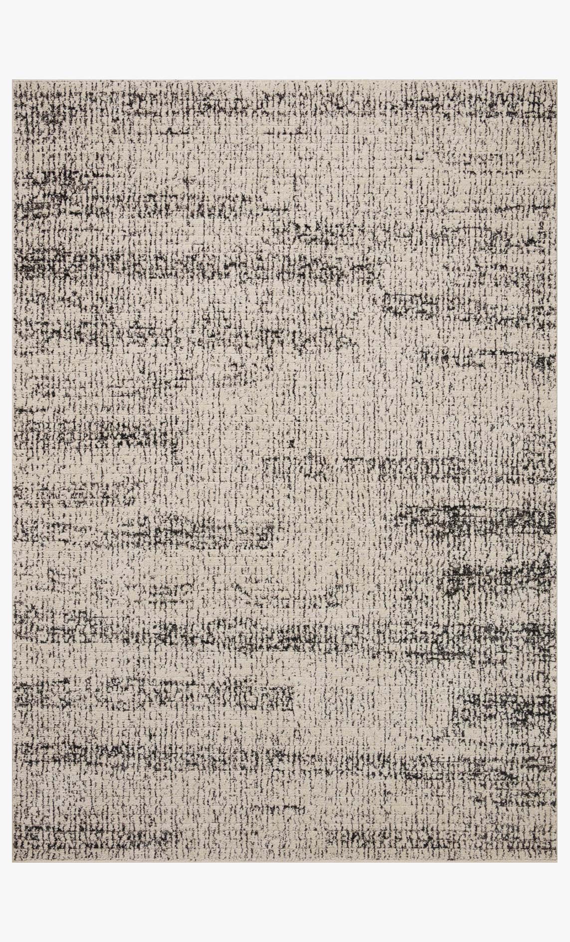 Rectangular oatmeal and charcoal accent rug with speckled abstract texture