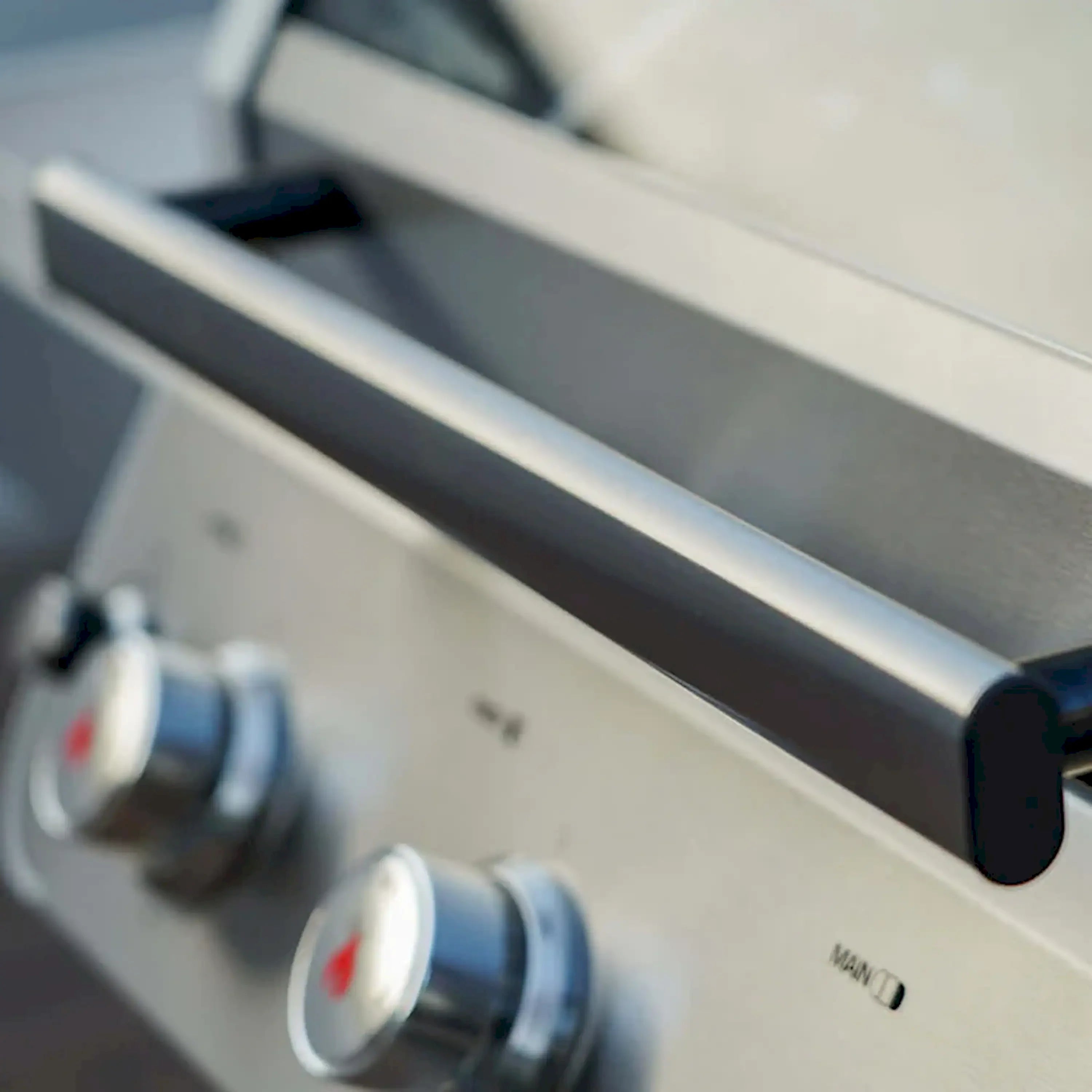 Propane grill control panel with burner knobs and stainless side handle