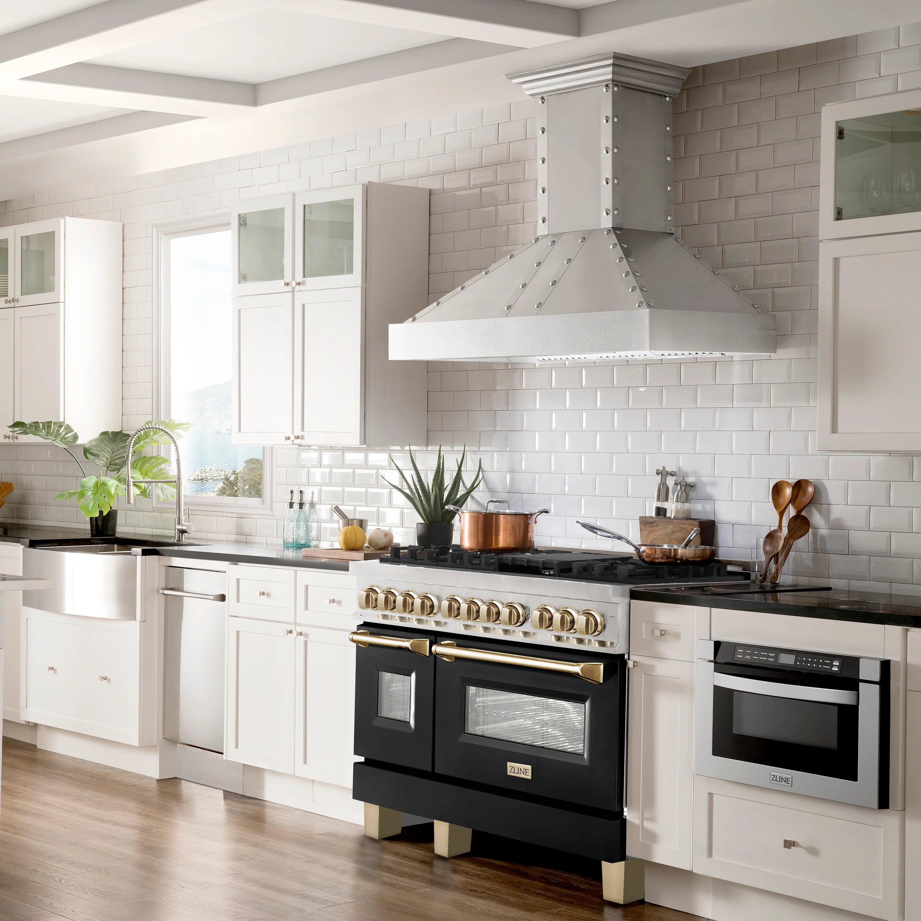 Stainless steel dual fuel range with black matte oven doors and gold-trimmed knobs