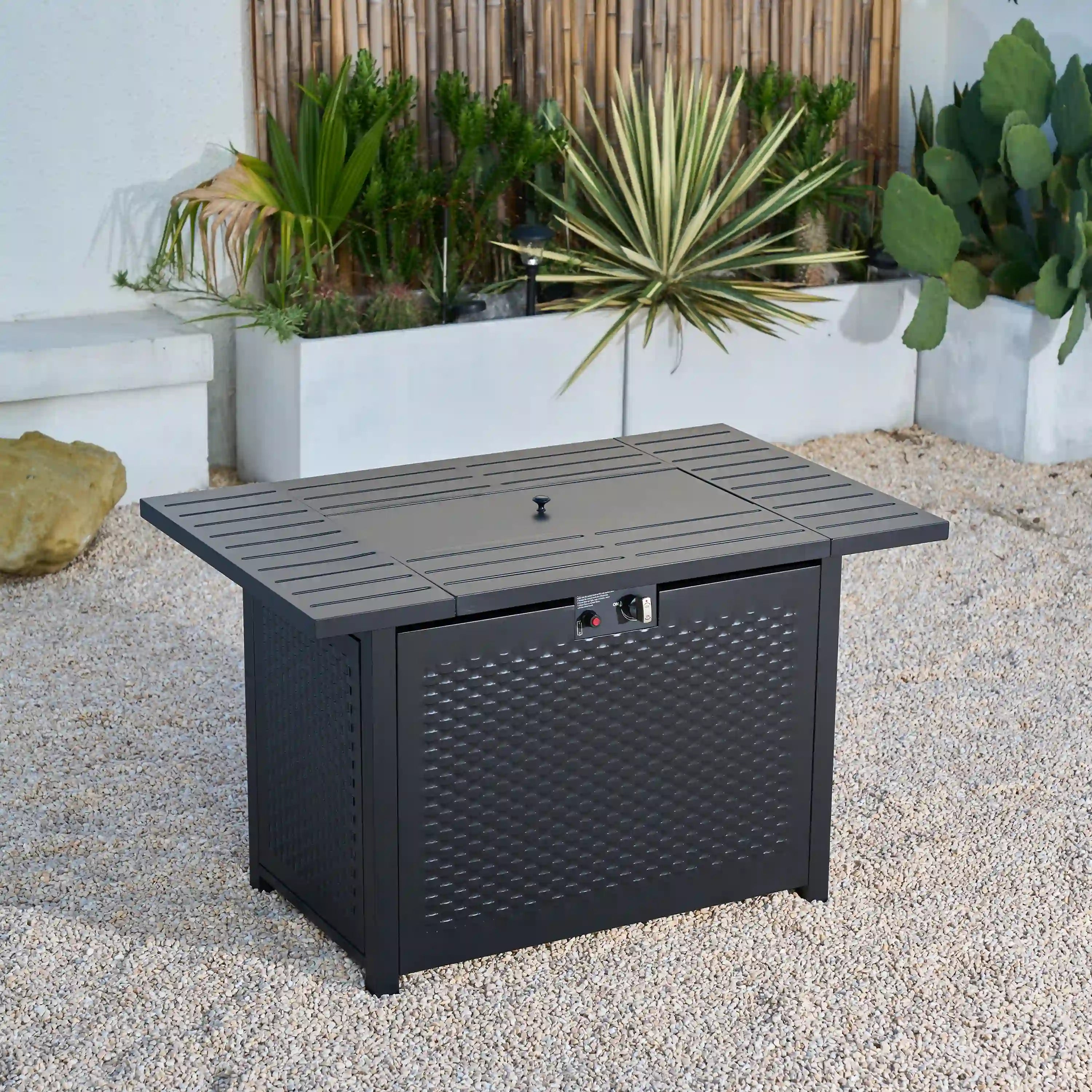 Outdoor propane gas fire pit table with slatted top, front access door, and control knobs