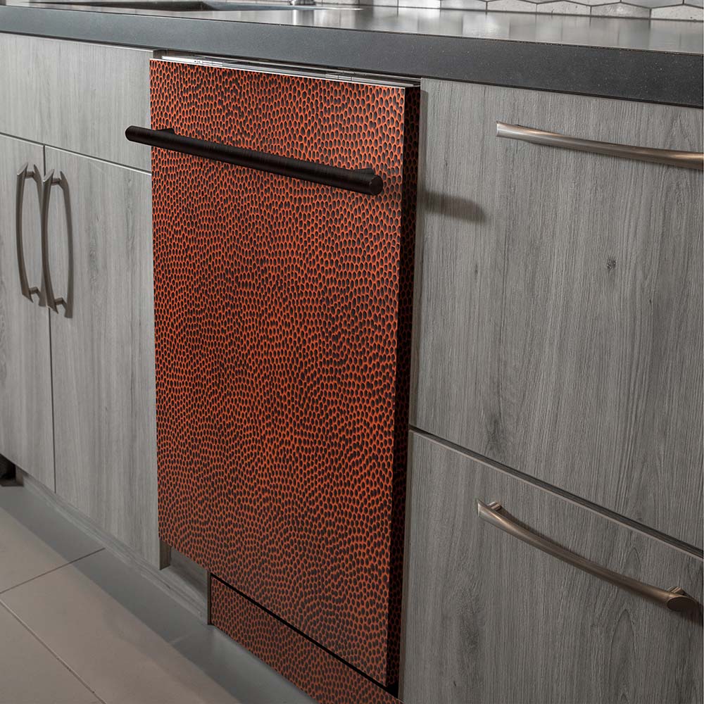 Built-in dishwasher view showing hand-hammered copper door with stainless handle.