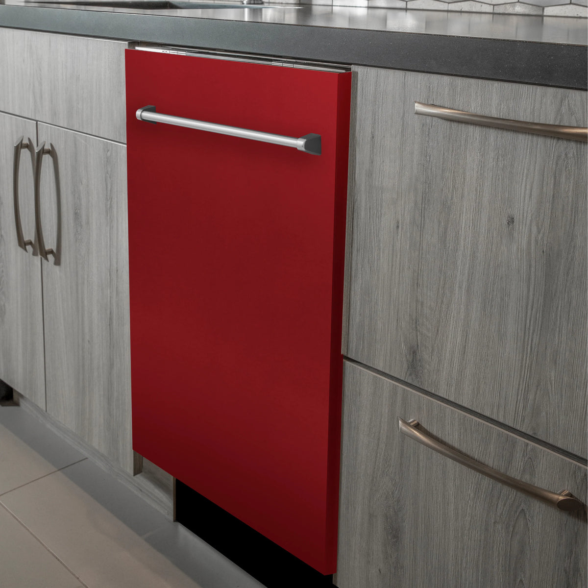 Red dishwasher door with traditional stainless handle installed in kitchen