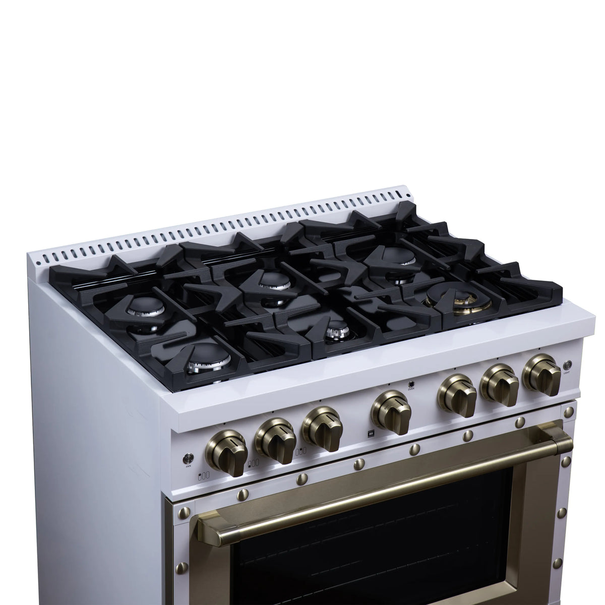White dual fuel range cooktop with black grates and brass control knobs