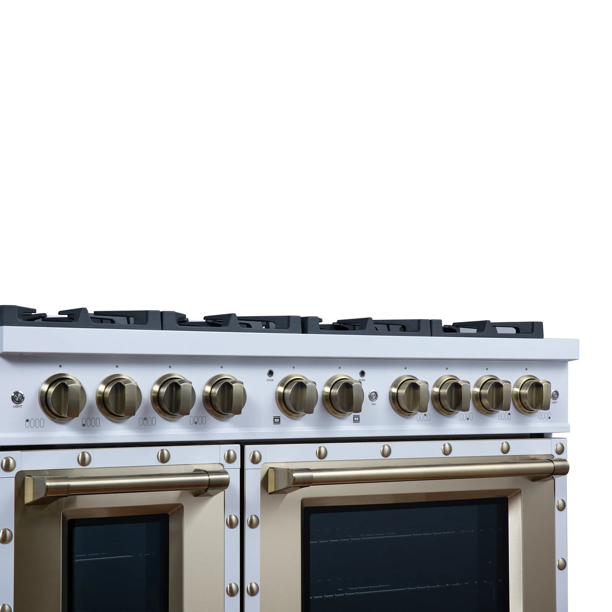 White dual fuel range control panel with brass knobs and black burner grates