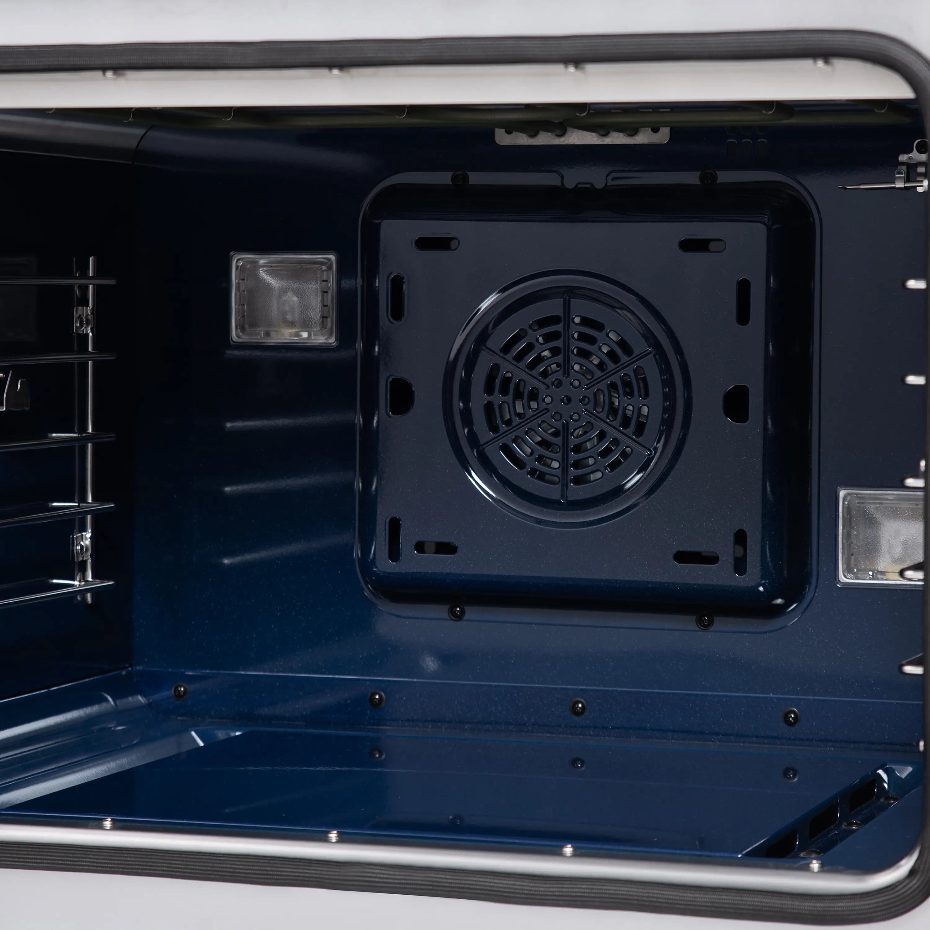 Dual fuel oven with interior view, circular fan vent and side rack supports.