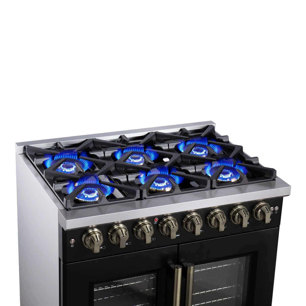 Black dual fuel range cooktop with lit blue burners and brass control knobs