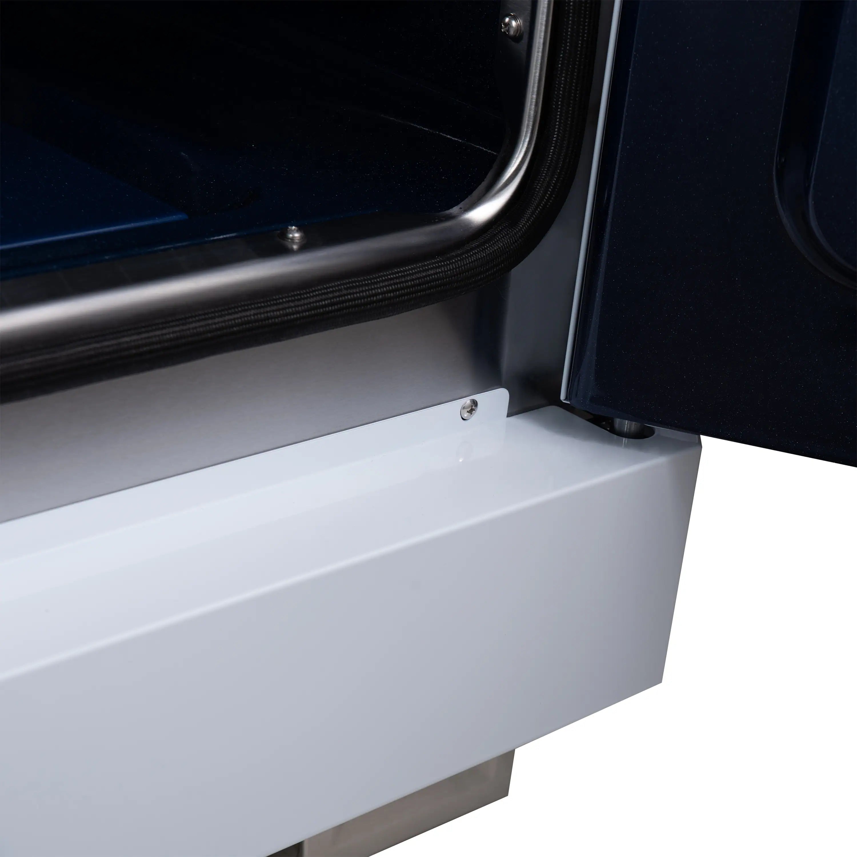 White range side panel with curved stainless trim near the open oven door