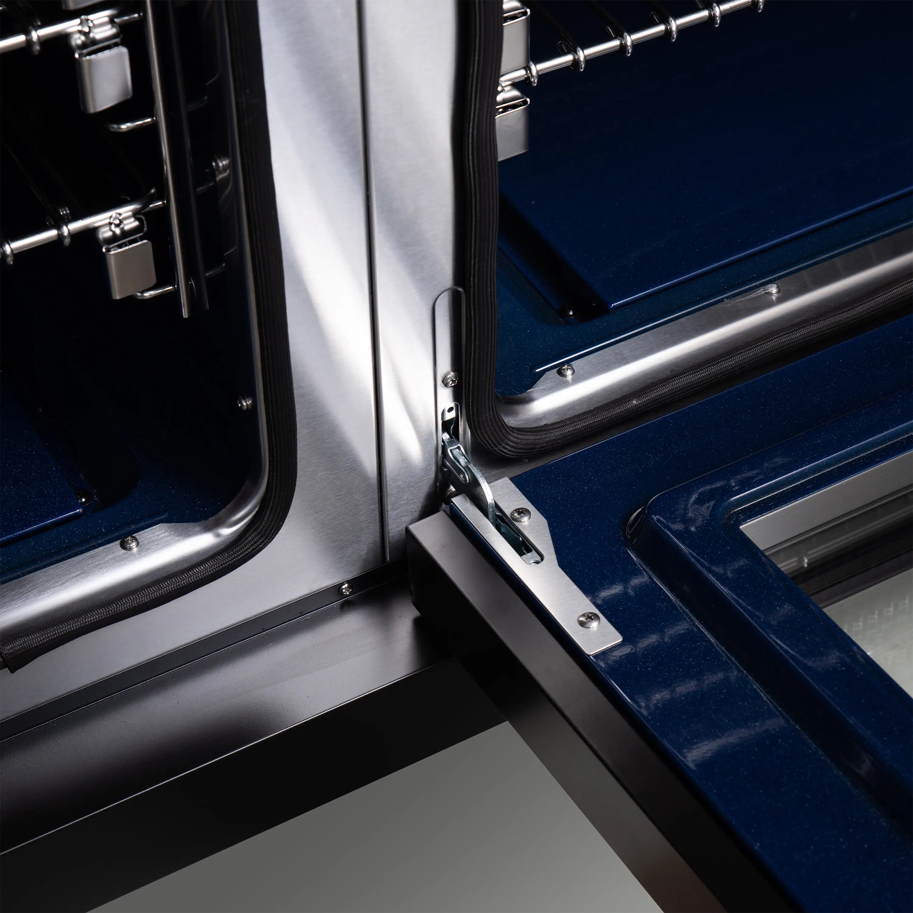 Range oven door hinge and interior rails, black with stainless frame.
