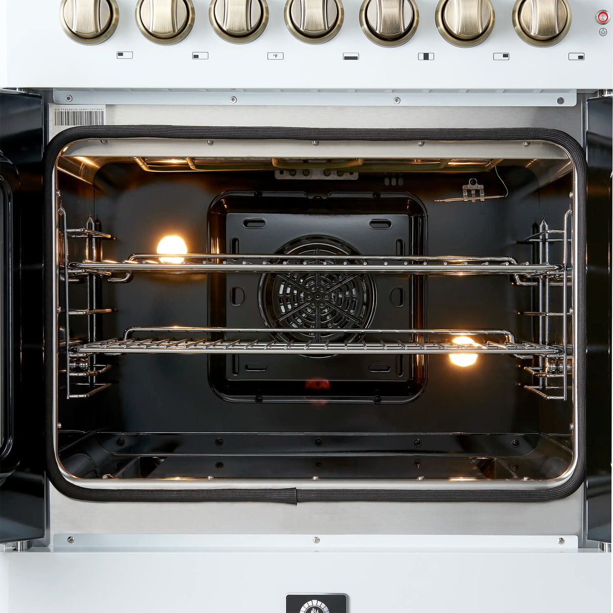 Dual fuel oven interior with metal racks and fan, viewed from open French doors.