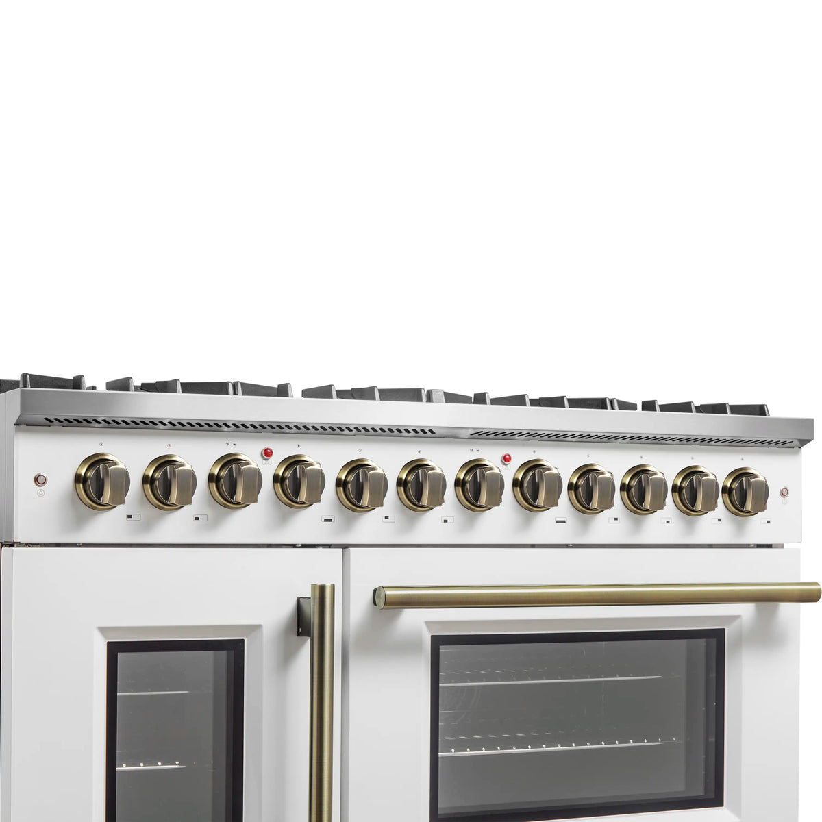 White dual fuel range close-up of brass control knobs and two dark oven door windows