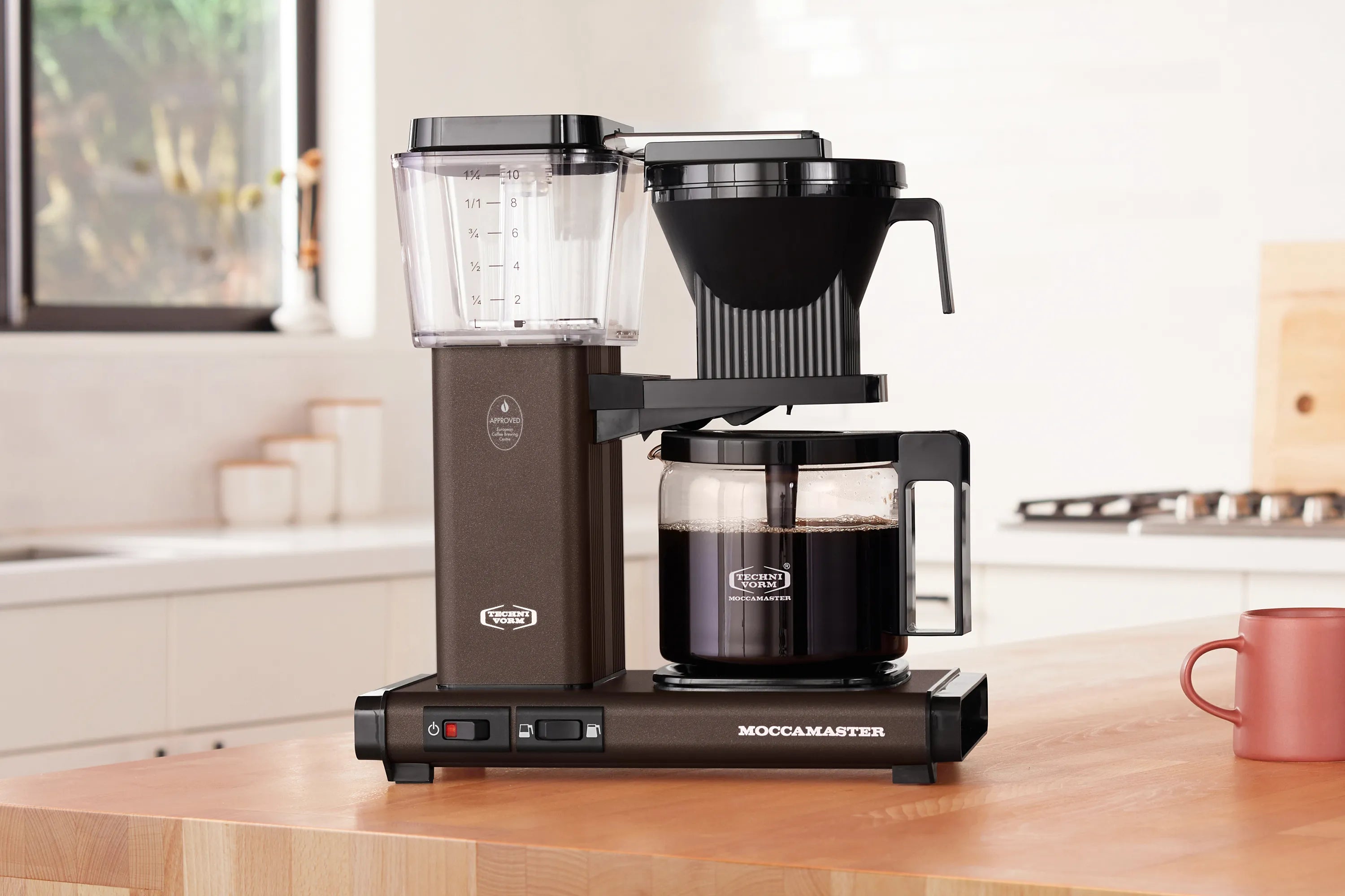 10-cup drip coffee maker with glass carafe, dark cocoa body and black pour spout
