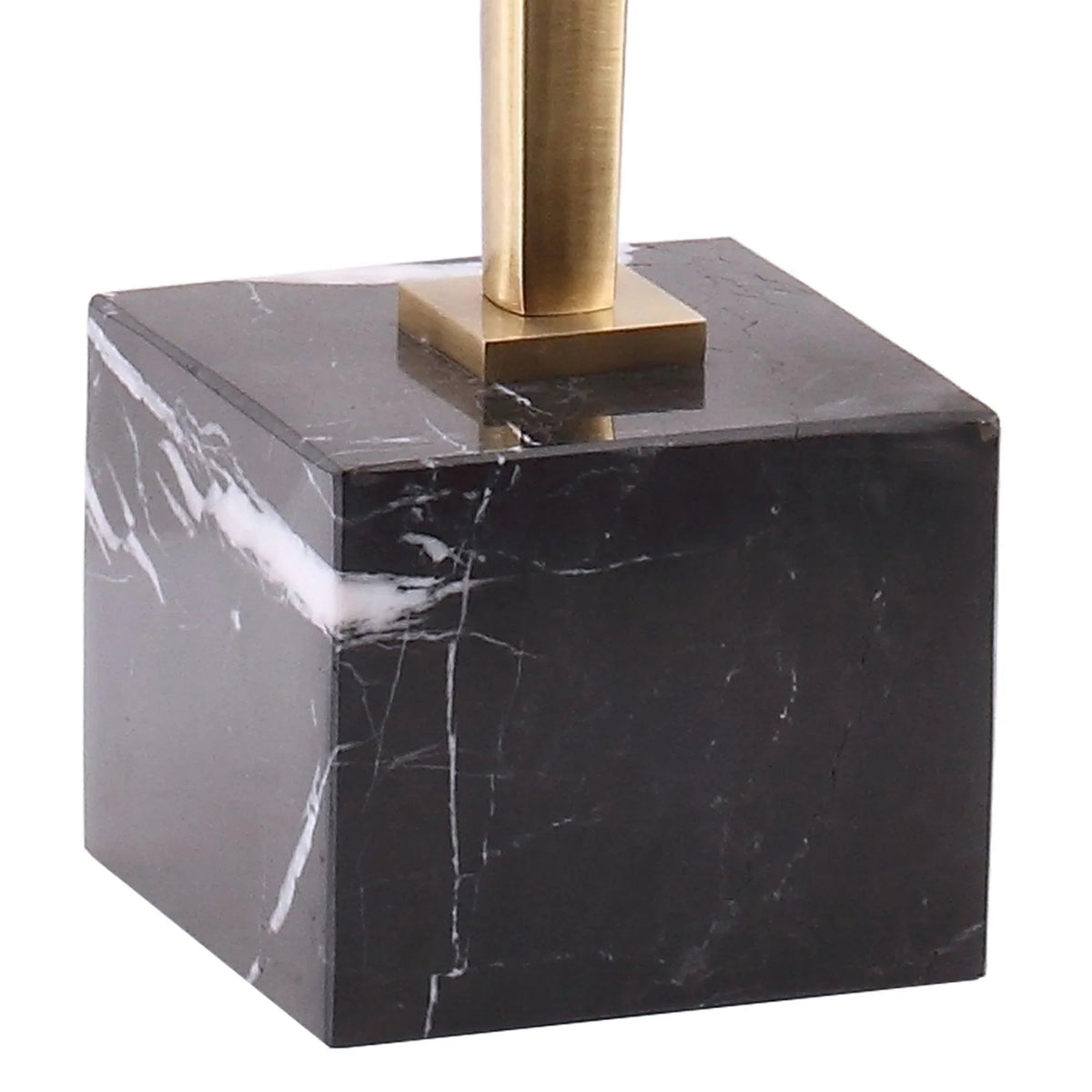 Square dark marble base with gold pedestal and glass tabletop, close-up