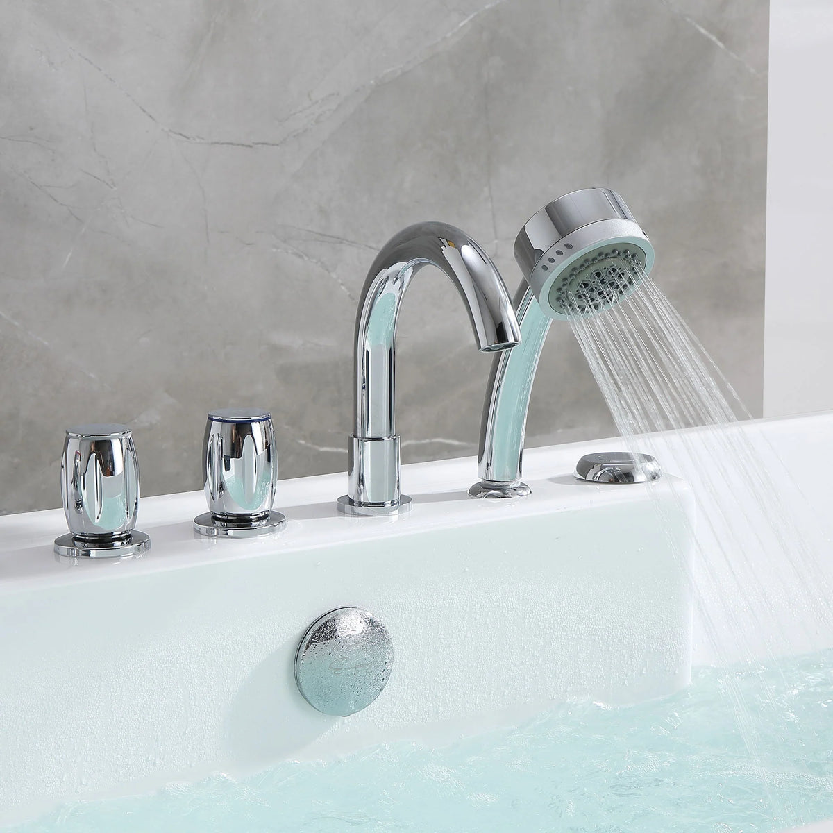 Chrome faucet and handheld shower on white acrylic whirlpool bathtub over aqua water.
