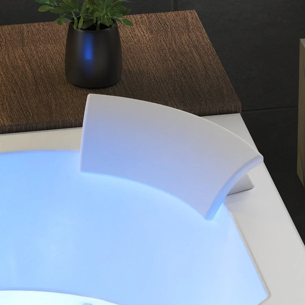 White whirlpool tub rim with blue LED glow near the back corner, open interior